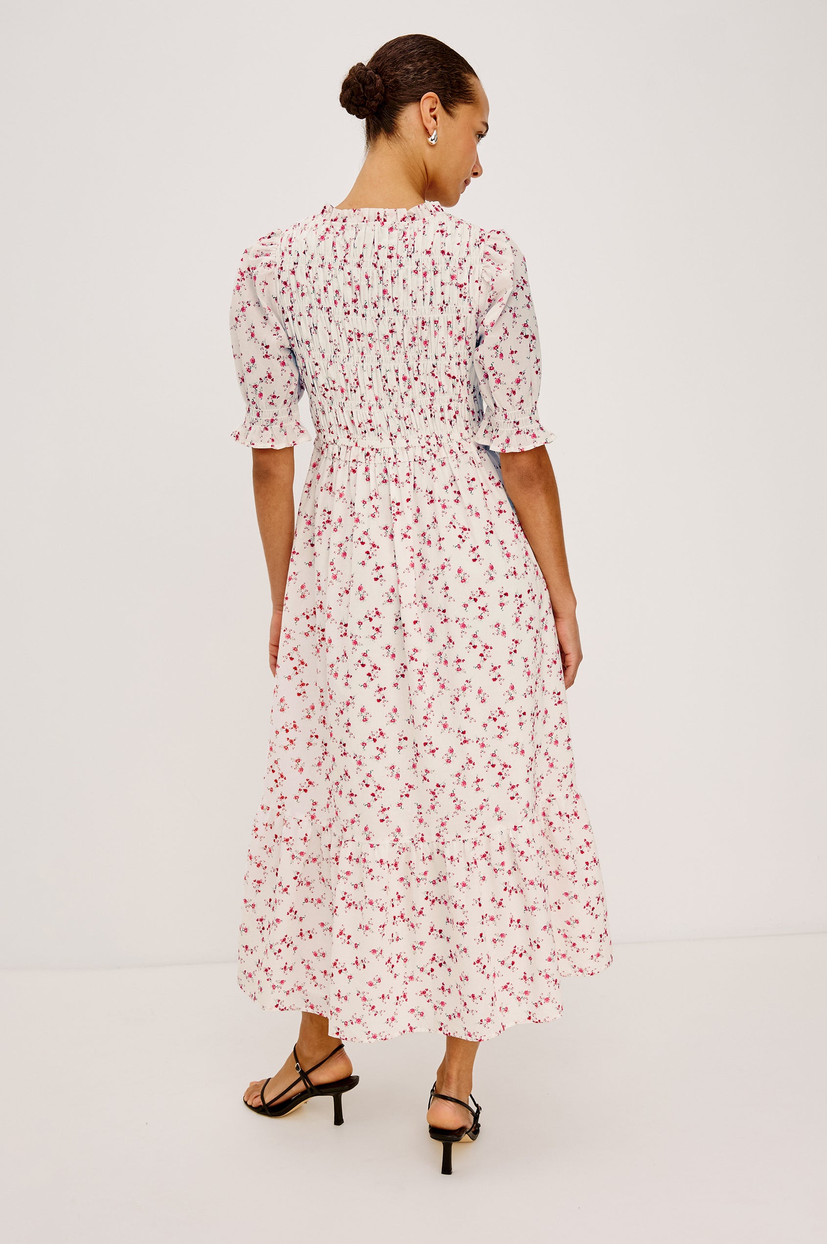 Sonica Midi Dress in Cotton With Fitted Smocked Bodice Plunging V-Neckline With Self-Ties Short Puff Sleeves and Single Tiered A-Line Skirt in Rouge Romantic Colorway - Full Body Back View Featured on Model