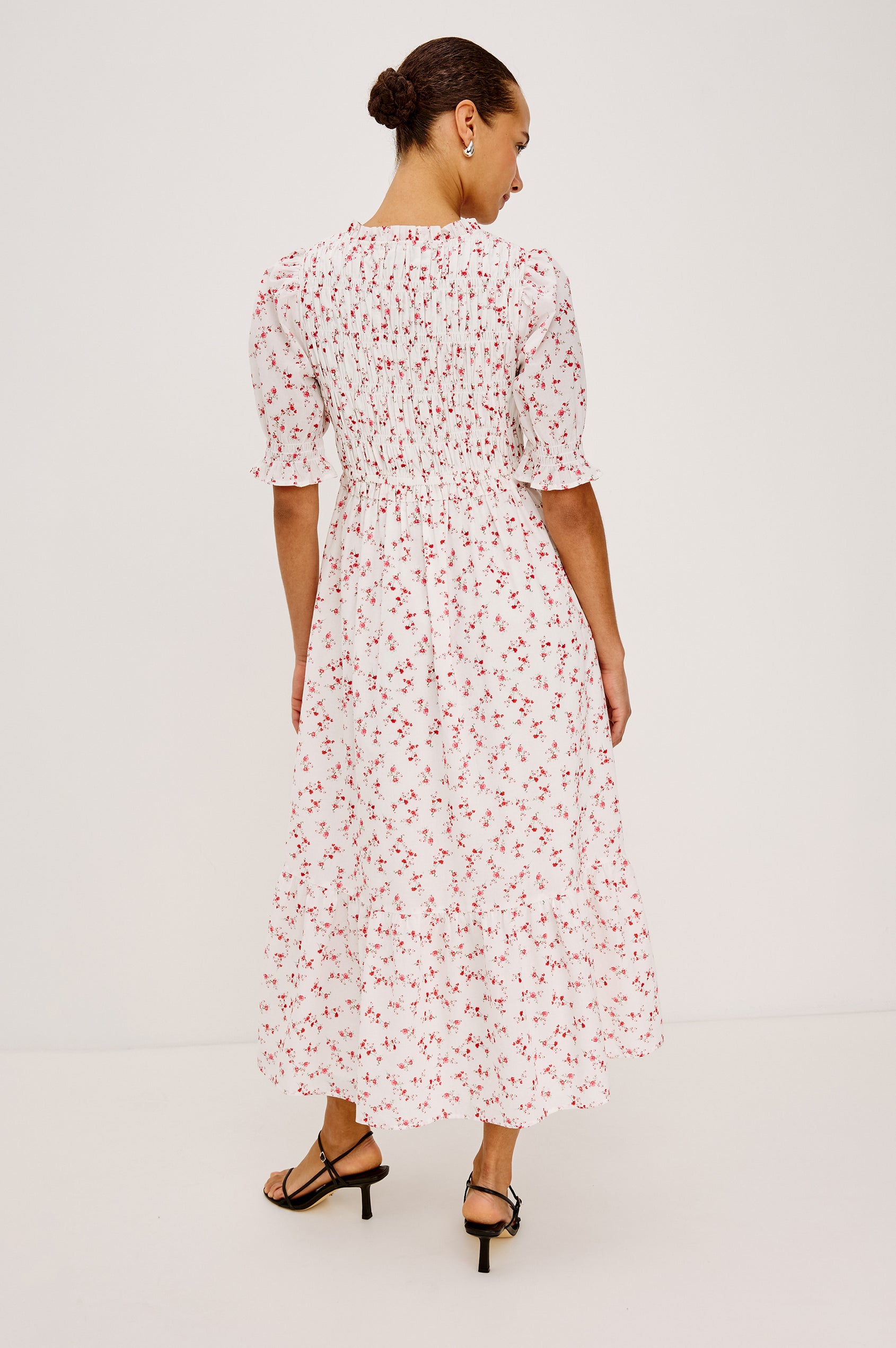 Sonica Midi Dress in Cotton With Fitted Smocked Bodice Plunging V-Neckline With Self-Ties Short Puff Sleeves and Single Tiered A-Line Skirt in Rouge Romantic Colorway - Full Body Back View Featured on Model