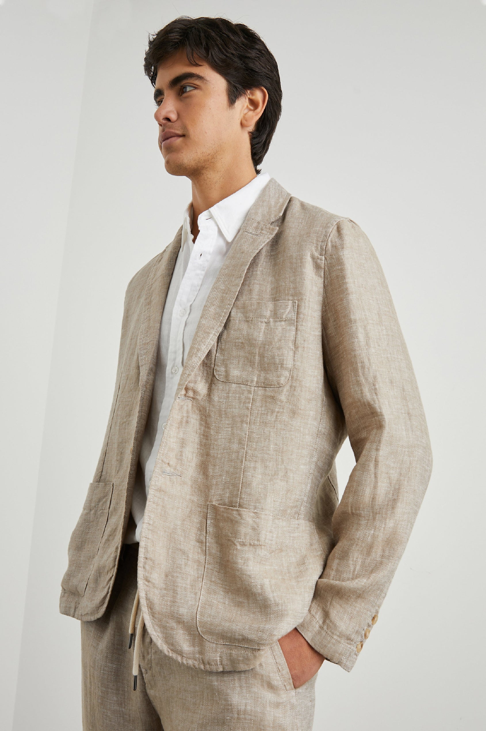 Sorrento Blazer with Two Button Closure, Two Front Flap Pockets, a Chest Patch Pocket and Three-Button Cuffs in Bulgur Colorway - Side View Featured on Model