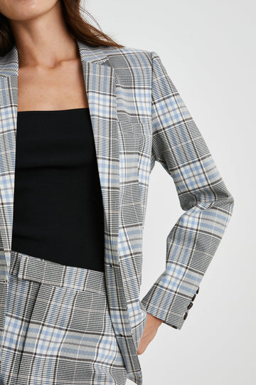 Stanton Blazer with Two Button Closure, Two Front Flap Pockets, a Chest Patch Pocket and Four-Button Cuffs in Cocoa Sky Check Colorway, a Grey, Blue and White Plaid - Front View Featured on Model
