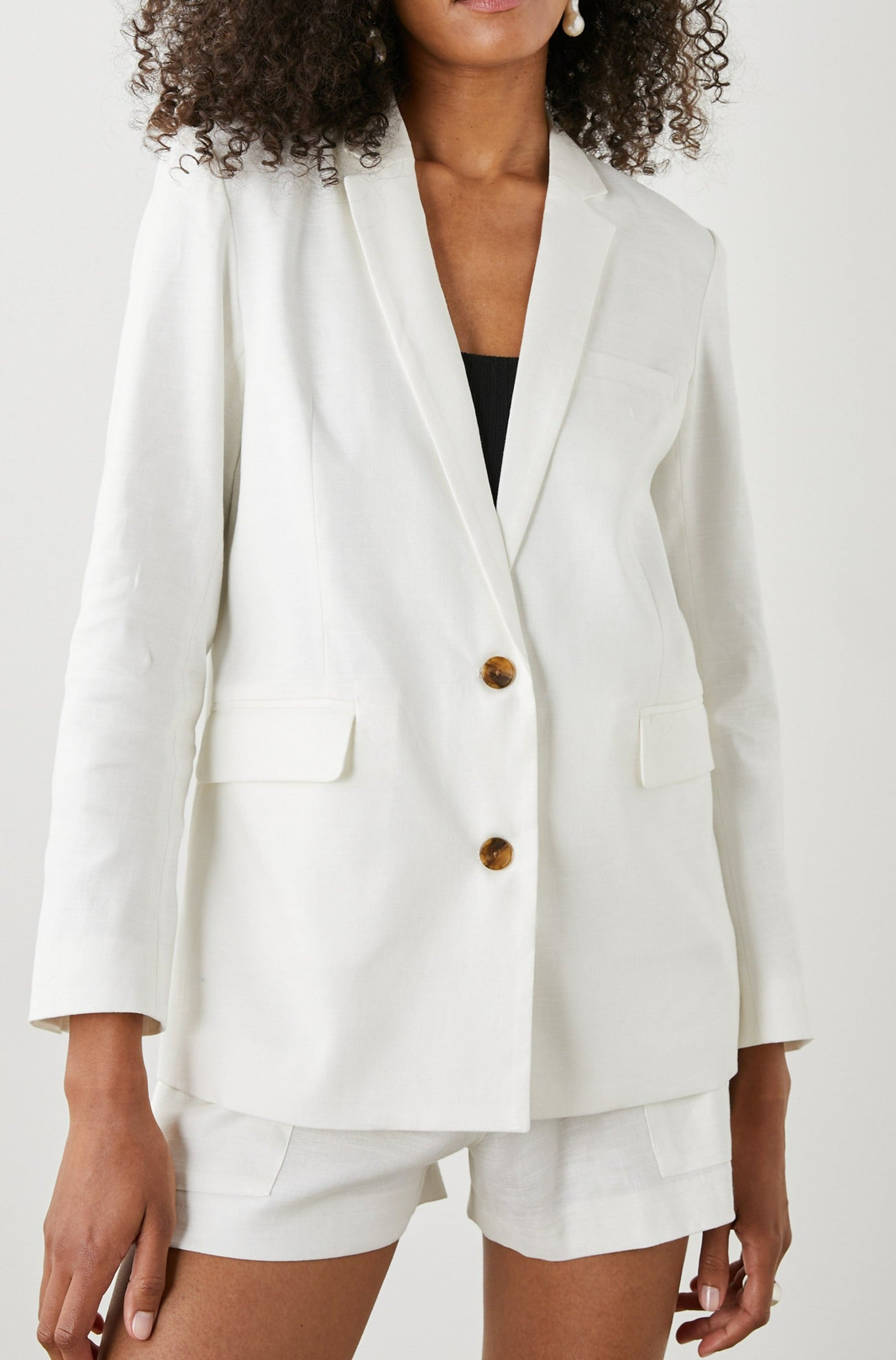 Stanton Blazer with Two Button Closure, Two Front Flap Pockets, a Chest Patch Pocket and Four-Button Cuffs in Creme Colorway - Front View Featured on Model