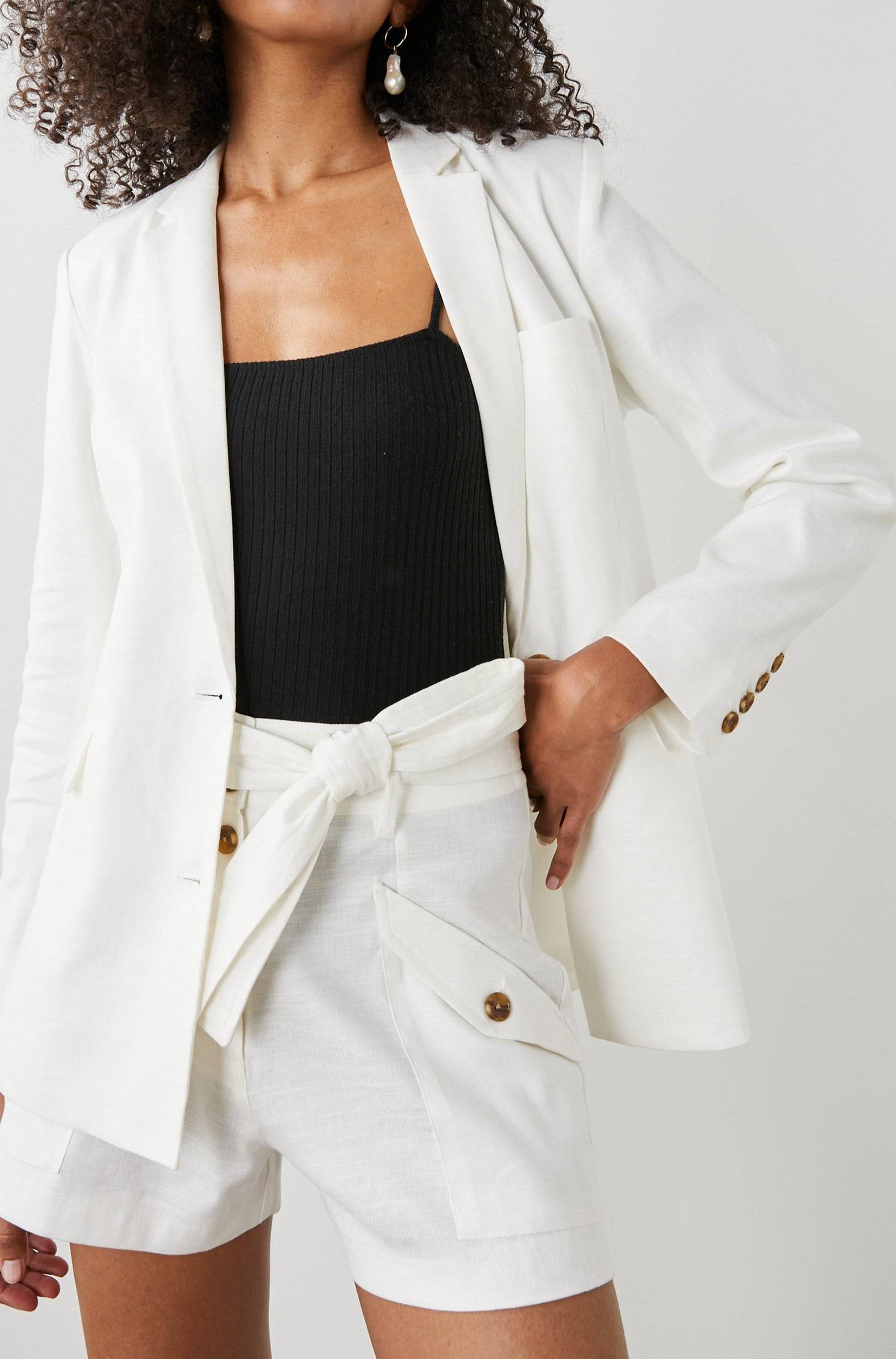 Stanton Blazer with Two Button Closure, Two Front Flap Pockets, a Chest Patch Pocket and Four-Button Cuffs in Creme Colorway - Front View Featured on Model