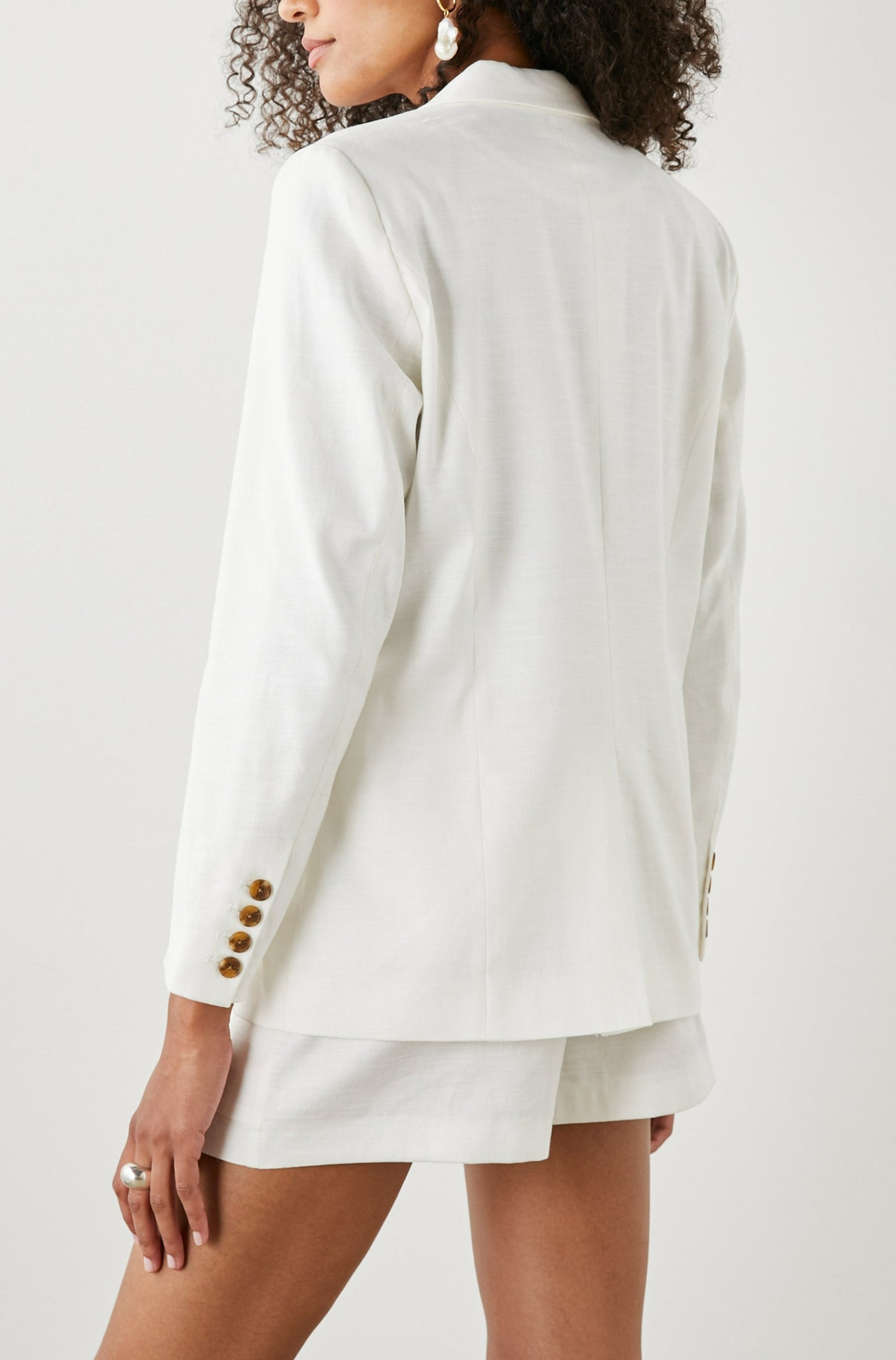 Stanton Blazer with Two Button Closure, Two Front Flap Pockets, a Chest Patch Pocket and Four-Button Cuffs in Creme Colorway - Back View Featured on Model