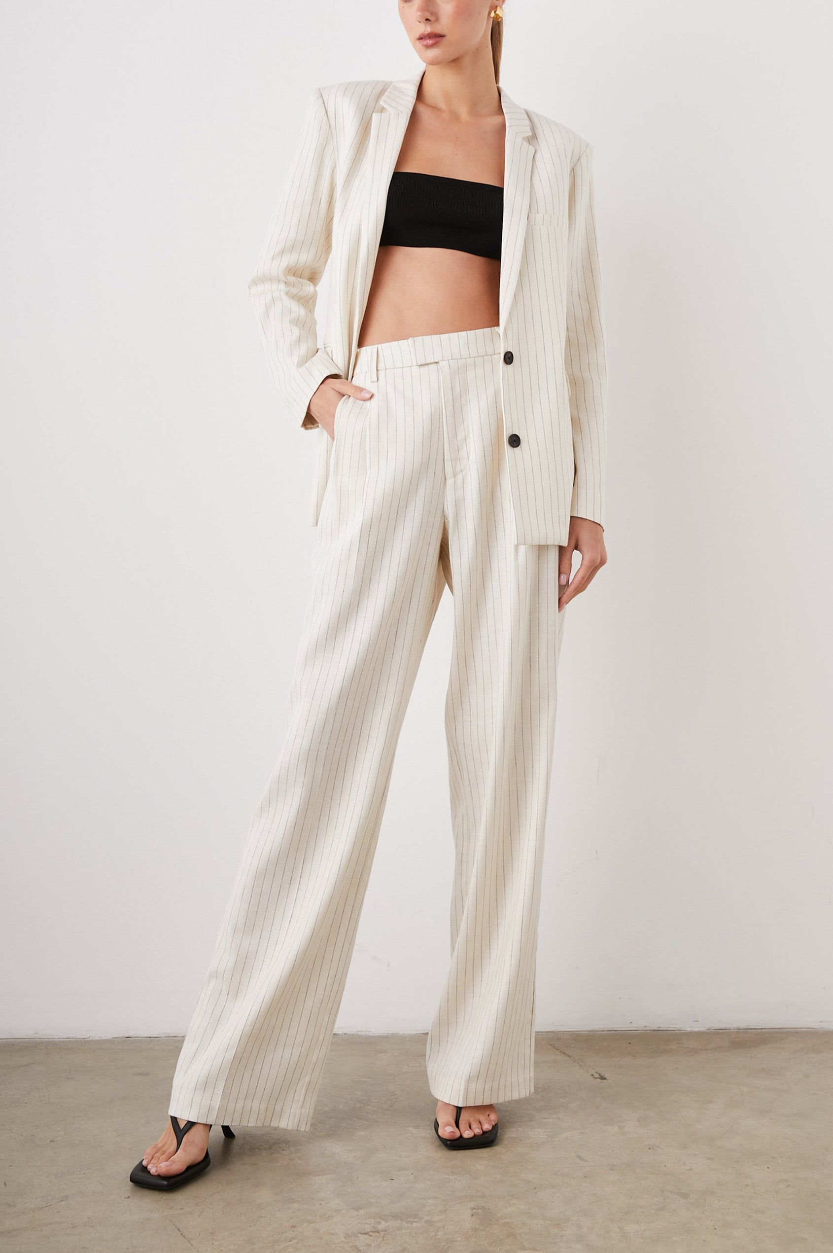 Stanton Blazer with Two Button Closure, Two Front Flap Pockets, a Chest Patch Pocket and Four-Button Cuffs in Ivory Pinstripe Colorway - Front Full Body View Featured on Model