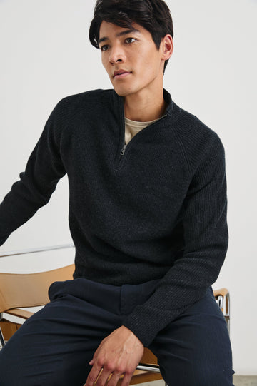 Stark Long-Sleeve Quarter Zip with a Mock Neck, Waffle Torso, and Ribbed Sleeves in Cast Iron Colorway - Front View Featured on Seated Model
