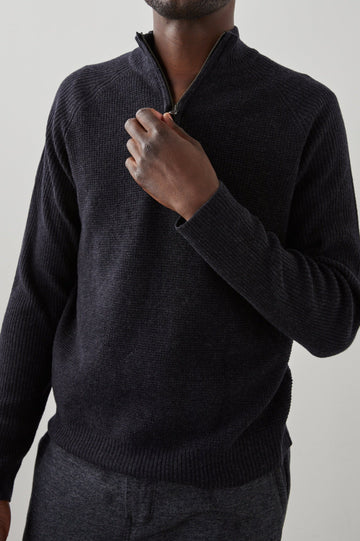 Stark Long-Sleeve Quarter Zip with a Mock Neck, Waffle Torso, and Ribbed Sleeves in Cast Iron Colorway - Front View Featured on Seated Model