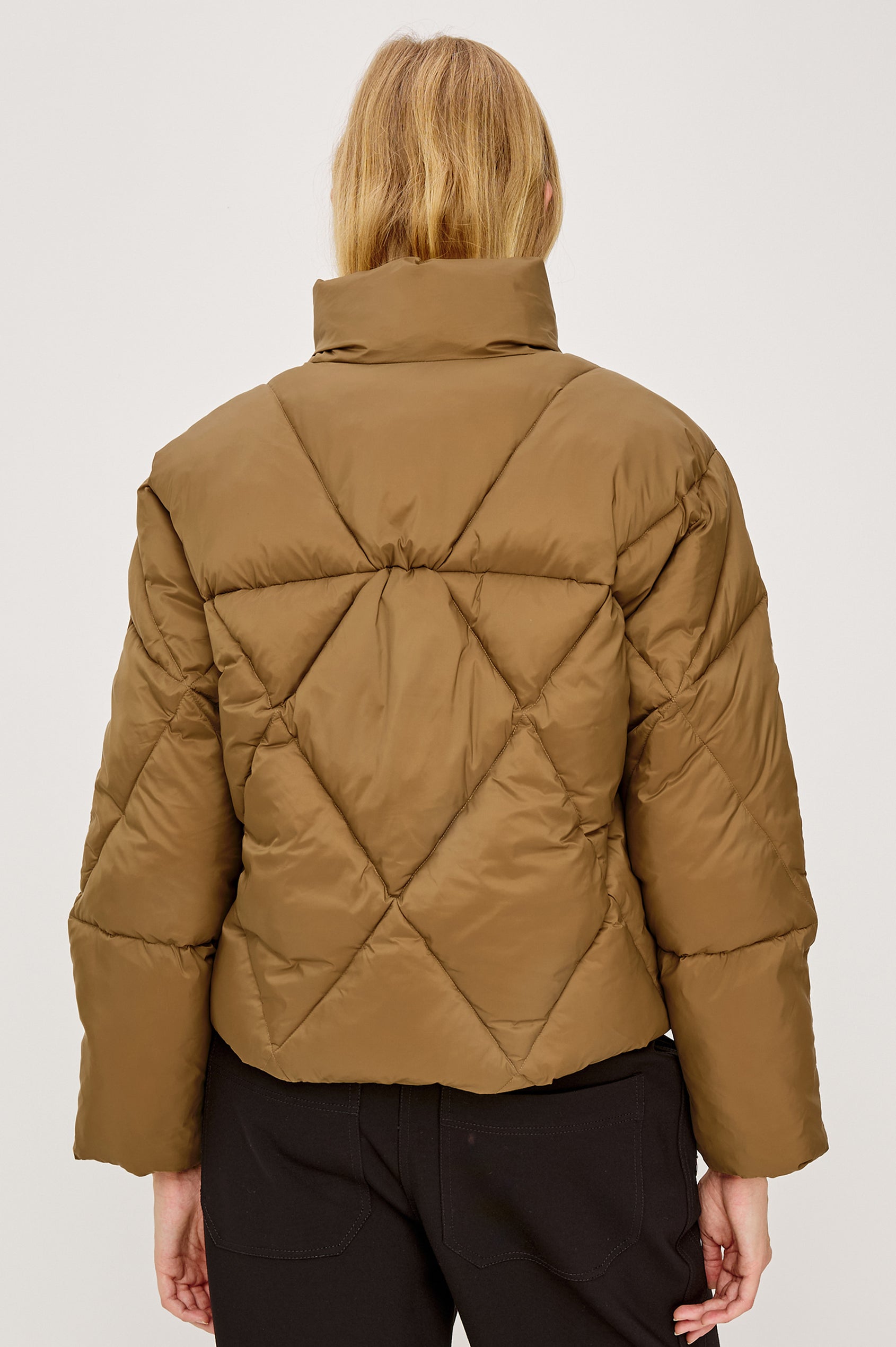 Summit Cropped Puffer Jacket With Stand Collar, Front Zipper, Quilted Detailing, Side Pockets, Tonal Branded Stamp, and Long Sleeves in Ginger Colorway - Upper Body Back View Featured on Model