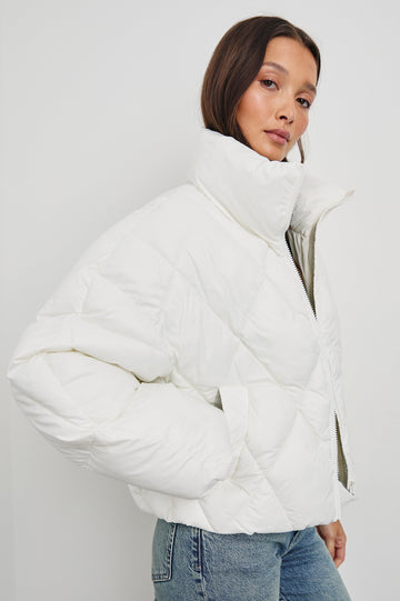 Summit Cropped Puffer Jacket with a Mid-Neck Collar, Two Pockets and a Rails Logo on the Arm in Ivory Colorway - Side View Featured on Model