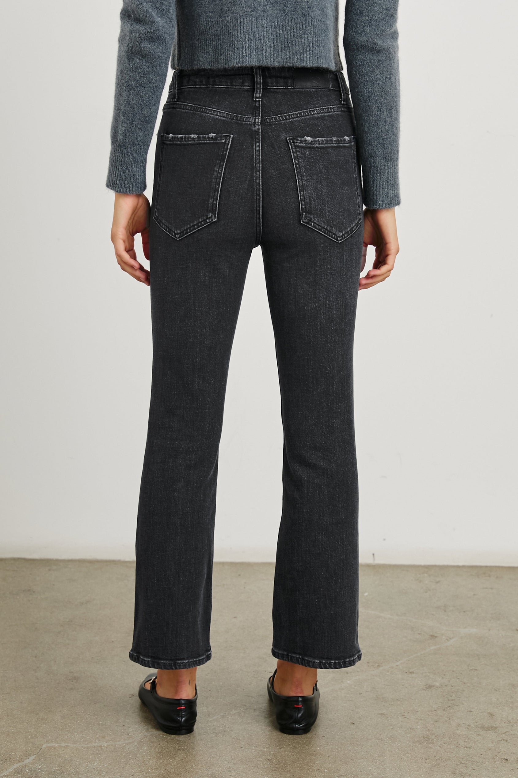 Sunset Crop Slim Fare Jeans with Belt Loops, Two Front Pockets plus a Coin Pocket and Two Back Patch Pockets in Black Pearl Colorway - Back View Featured on Model
