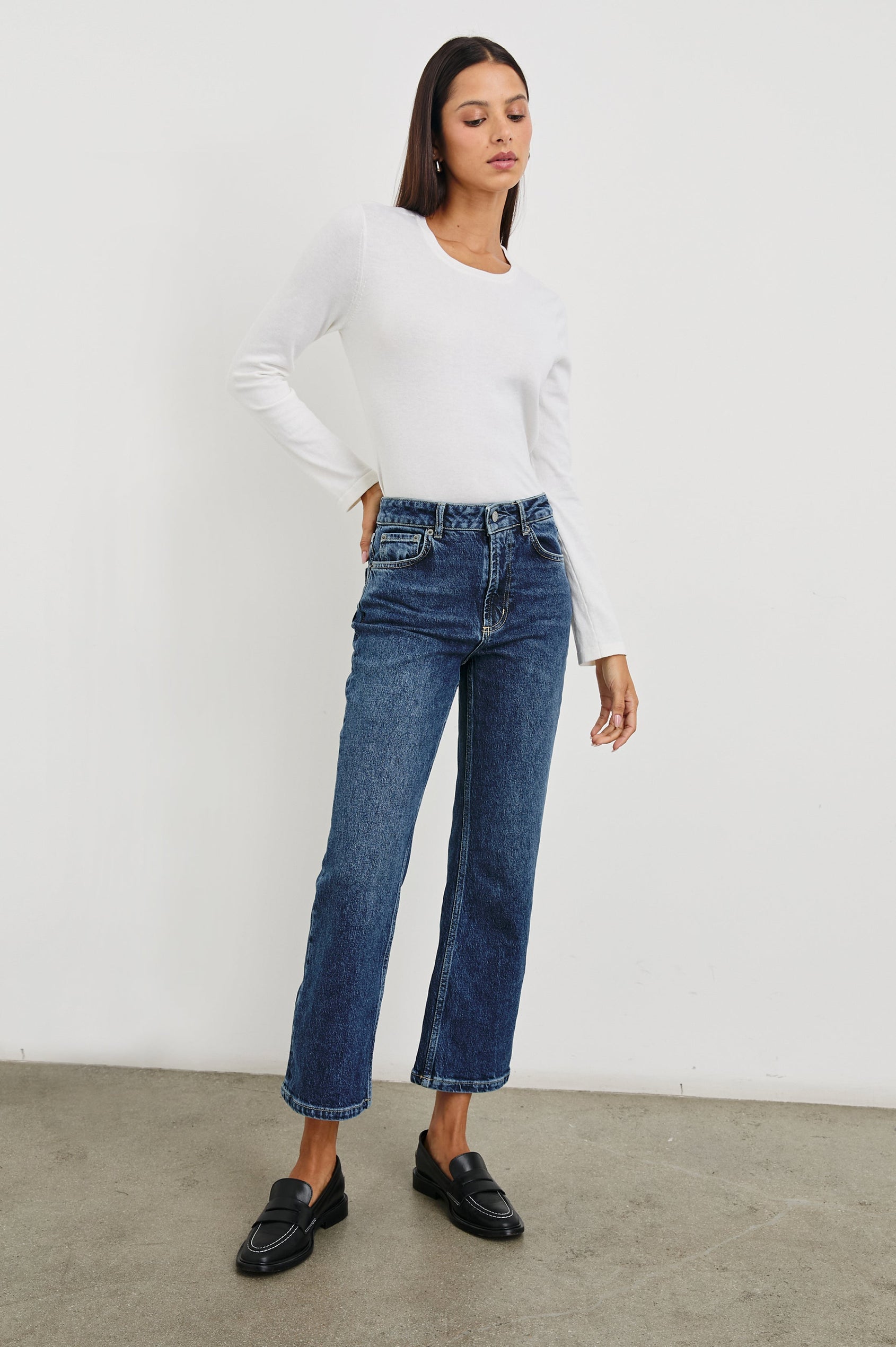 Sunset Crop Slim Fare Jeans with Belt Loops, Two Front Pockets plus a Coin Pocket and Two Back Patch Pockets in Collegiate Blue Colorway - Front Full Body View Featured on Model