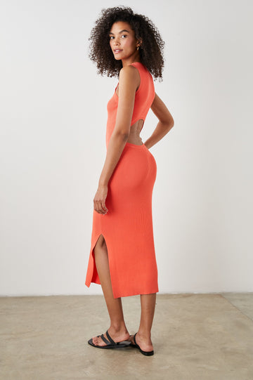 Syd Ribbed, Sleeveless Midi Dress with Wide Shoulder Straps, a Side Slit, and a Cutout that Spans the Lower Back in Black Colorway - Side Full Body View Featured on Model  