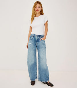 Woman wearing petite denim with black woven shoes and a white top