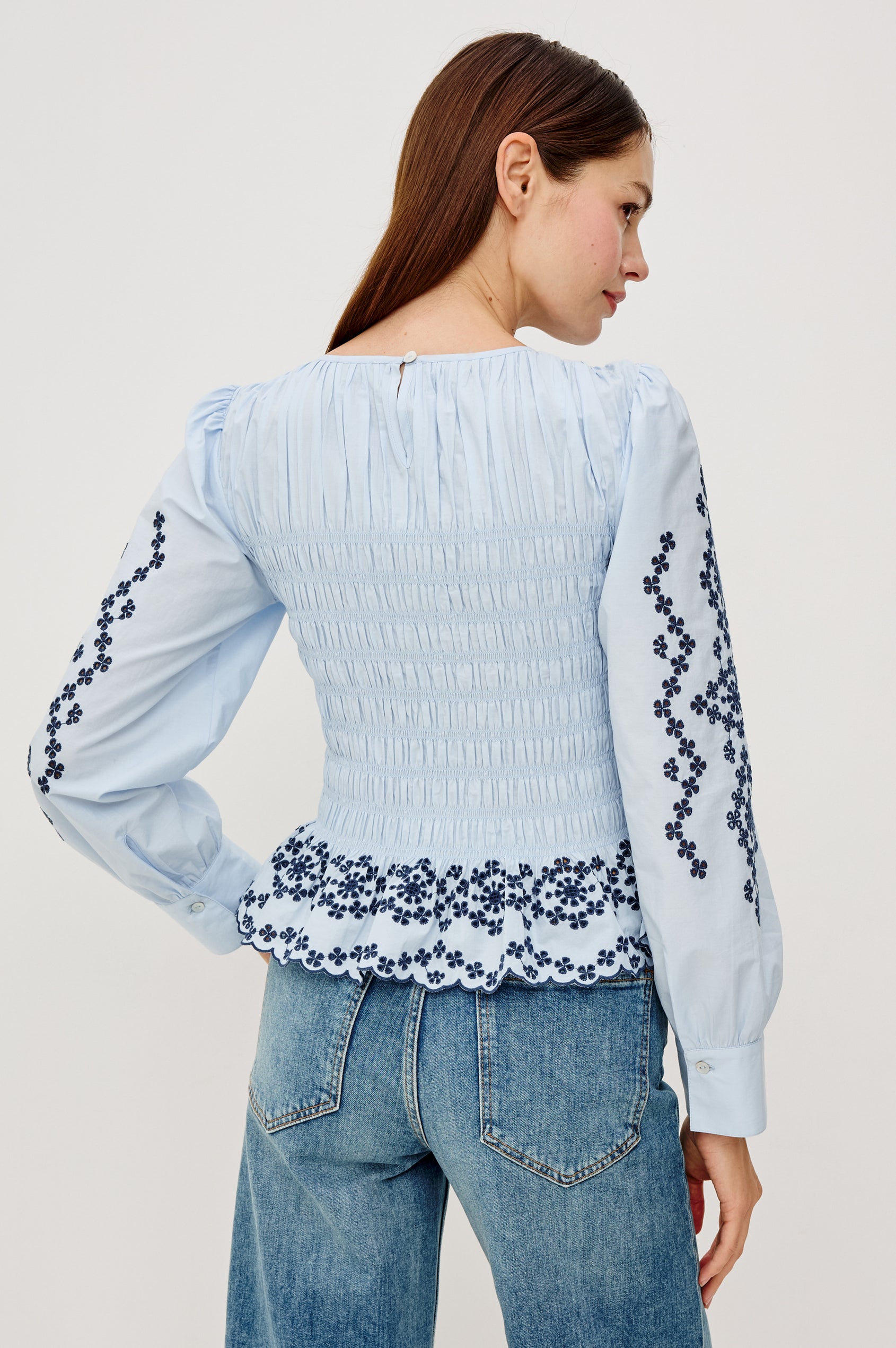Tabi Blouse Top in Poplin With Smocked Body, Long Puff Sleeves With Fitted Cuffs, Contrast Embroidered Detailing, and Back Keyhole Cutout in Blue Bird Colorway - Upper Body Back View Featured on Model