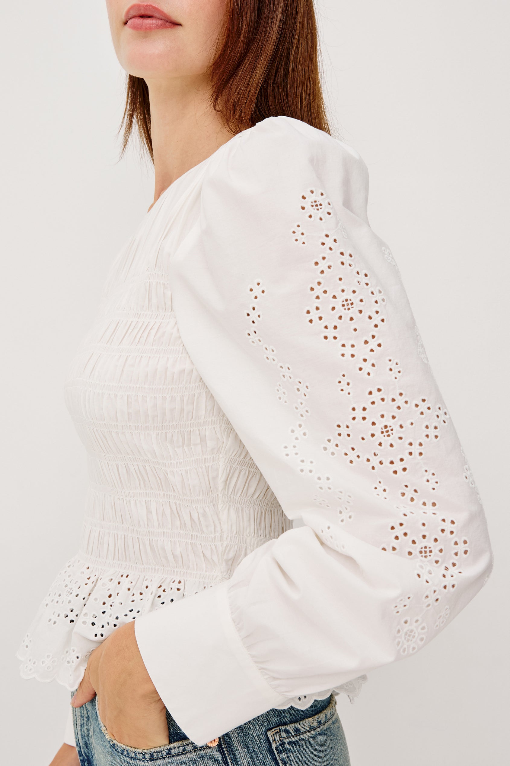 Tabi Blouse Top in Poplin With Smocked Body, Long Puff Sleeves With Fitted Cuffs, Embroidered Detailing, and Back Keyhole Cutout in White Embroidery Colorway - Upper Body Side Close Up View Featured on Model