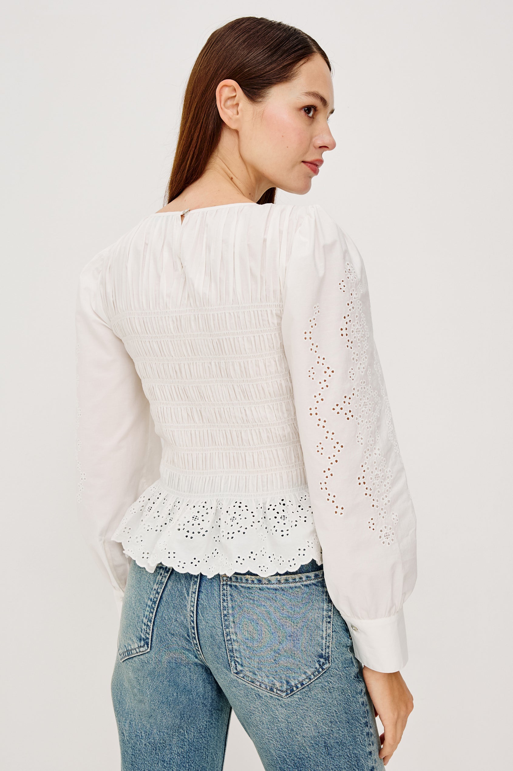 Tabi Blouse Top in Poplin With Smocked Body, Long Puff Sleeves With Fitted Cuffs, Embroidered Detailing, and Back Keyhole Cutout in White Embroidery Colorway - Upper Body Back View Featured on Model