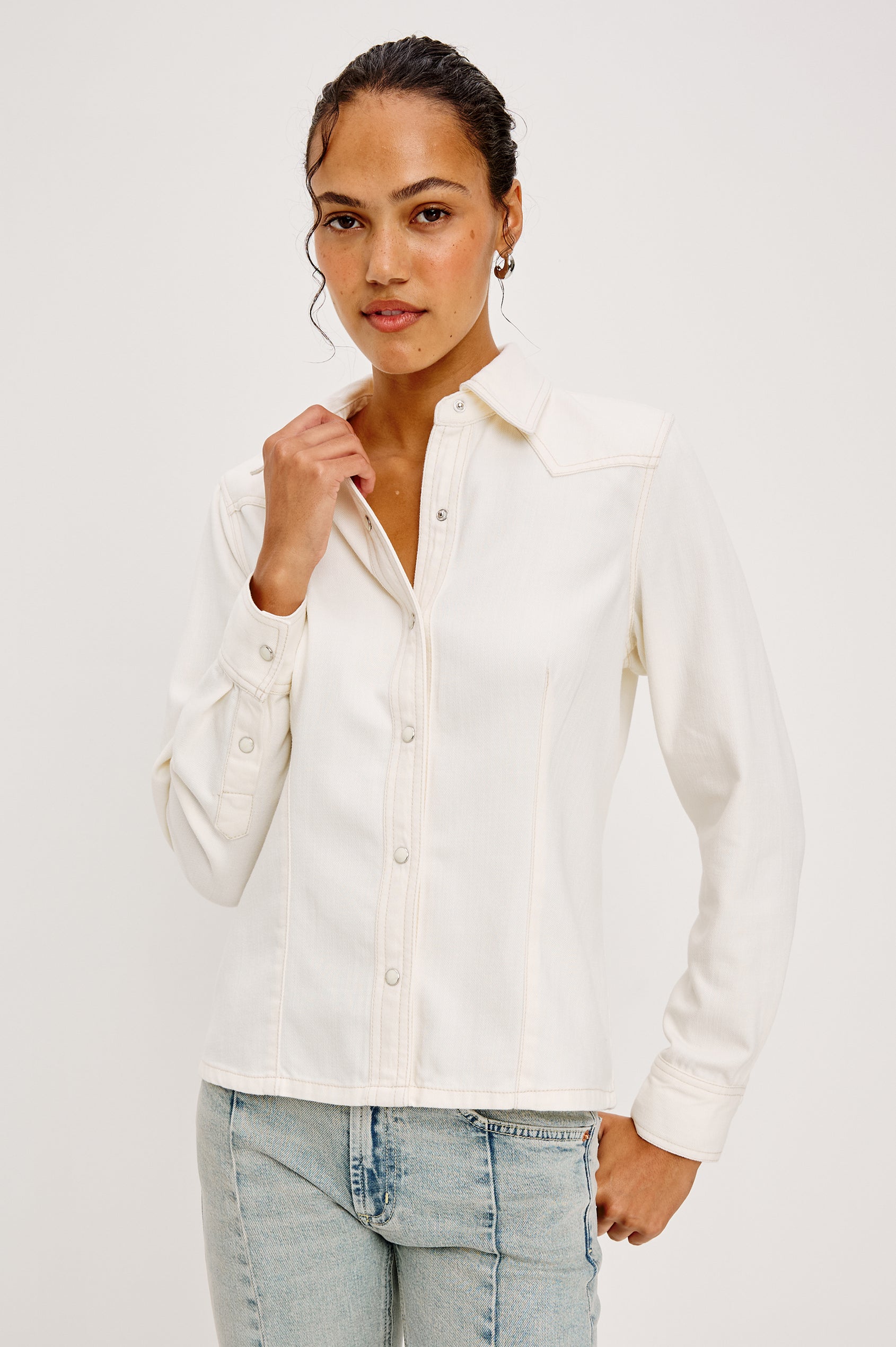 Taiana Shirt in Cotton Lyocell Denim With Collar Front and Back Darting Western Yoke Front Snap Buttons Long Sleeves and Fitted Silhouette in Ivory Colorway - Upper Body Front View Featured on Model