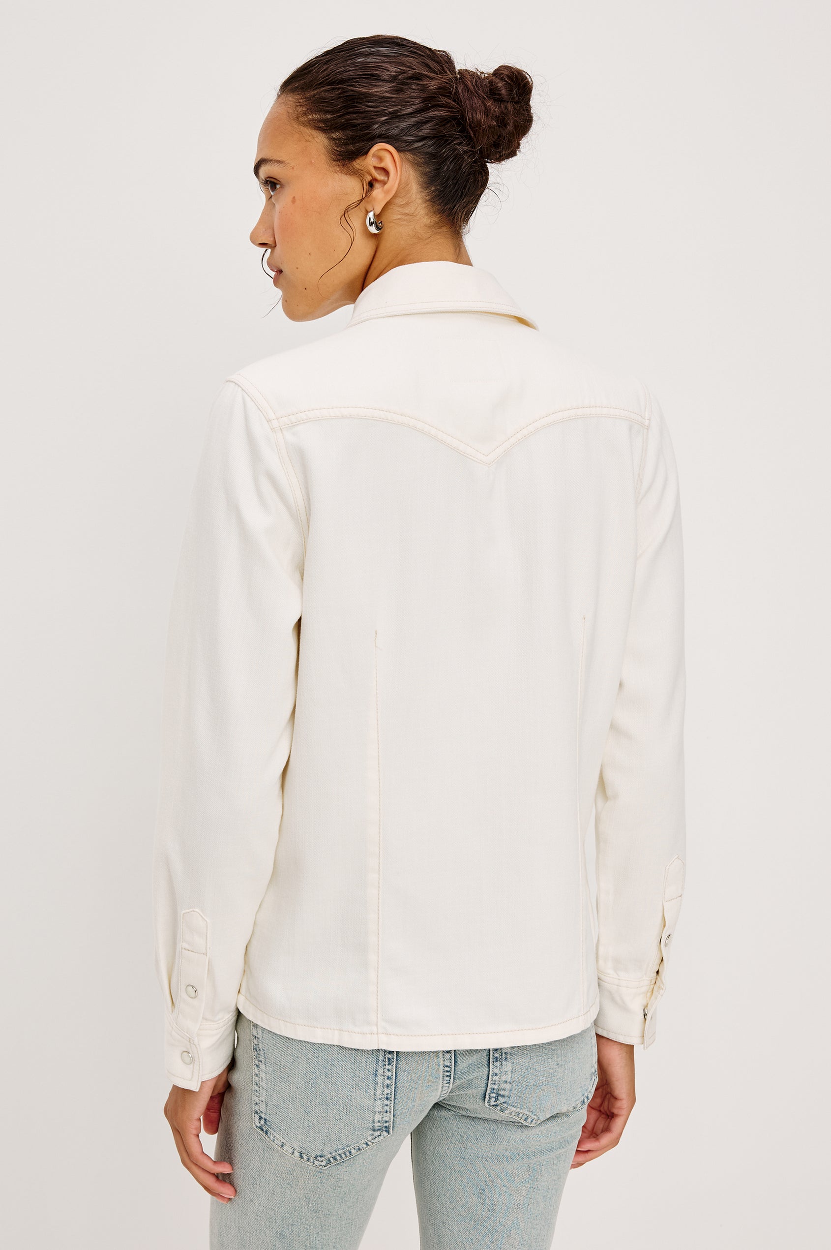 Taiana Shirt in Cotton Lyocell Denim With Collar Front and Back Darting Western Yoke Front Snap Buttons Long Sleeves and Fitted Silhouette in Ivory Colorway - Full Body Back View Featured on Model