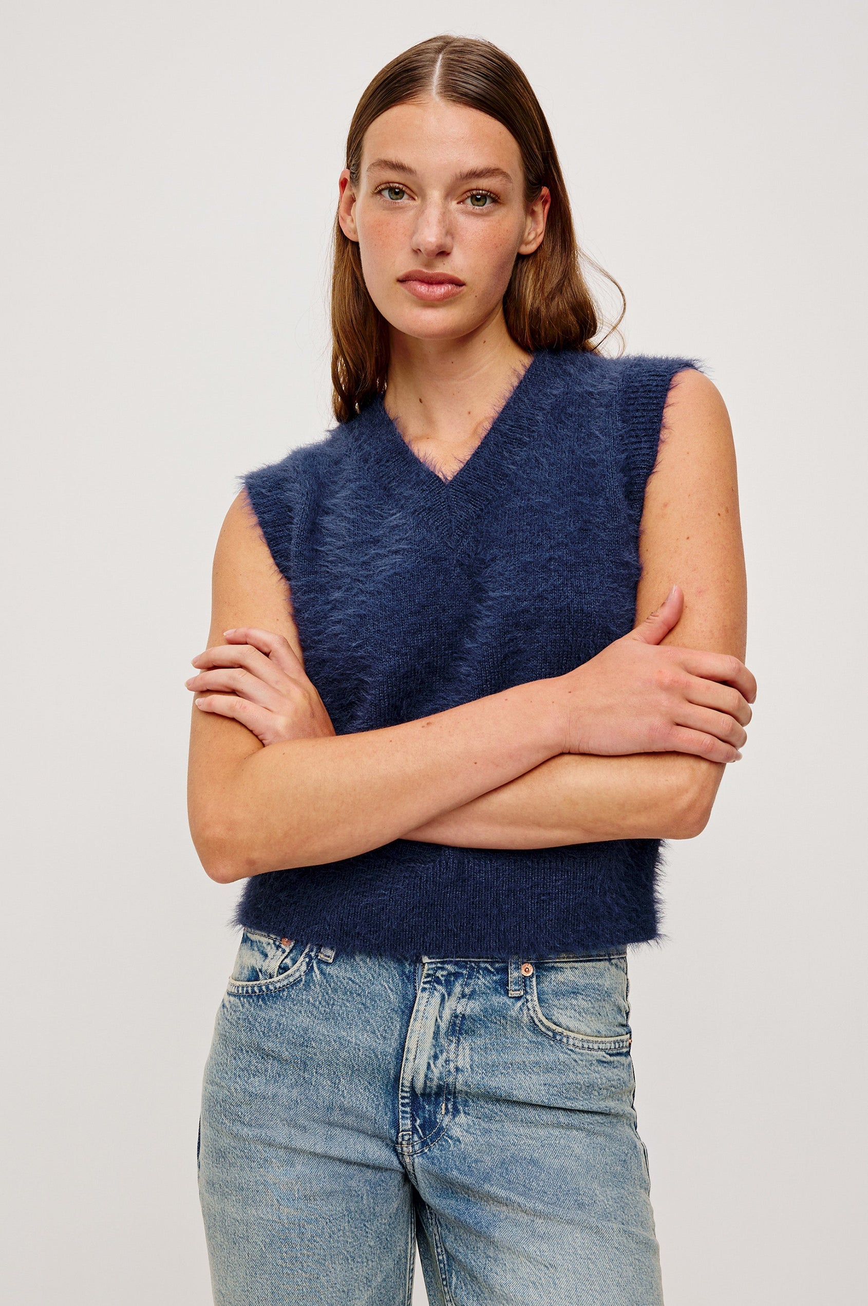 The Talli is a sweater best with a v-neck and rib trims in Navy colorway. Front view featured on model.
