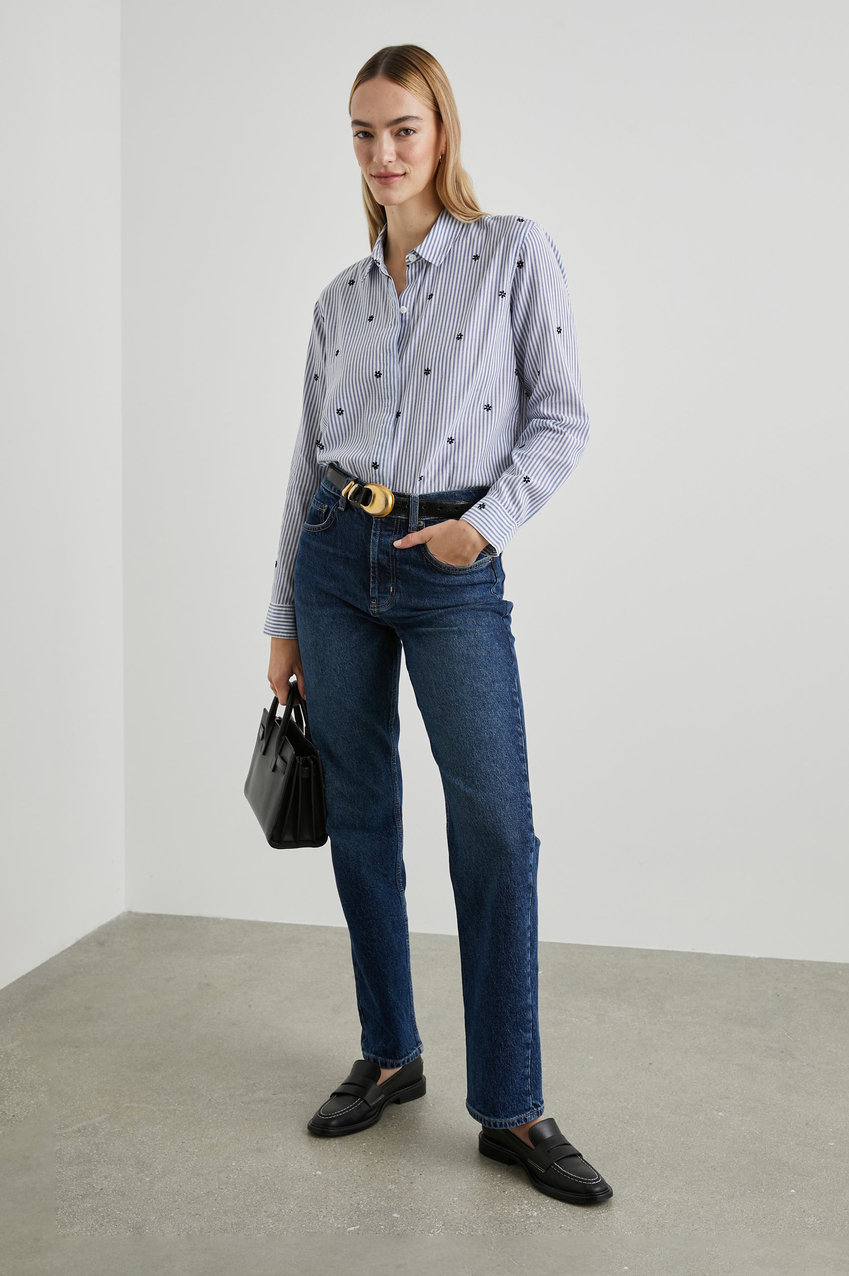 Taylor Long-Sleeve Button Up with Small Dark Navy Daisies in Flocked Daisies Colorway, with Blue and White Vertical Stripes - Front Tucked Full Body View Featured on Model