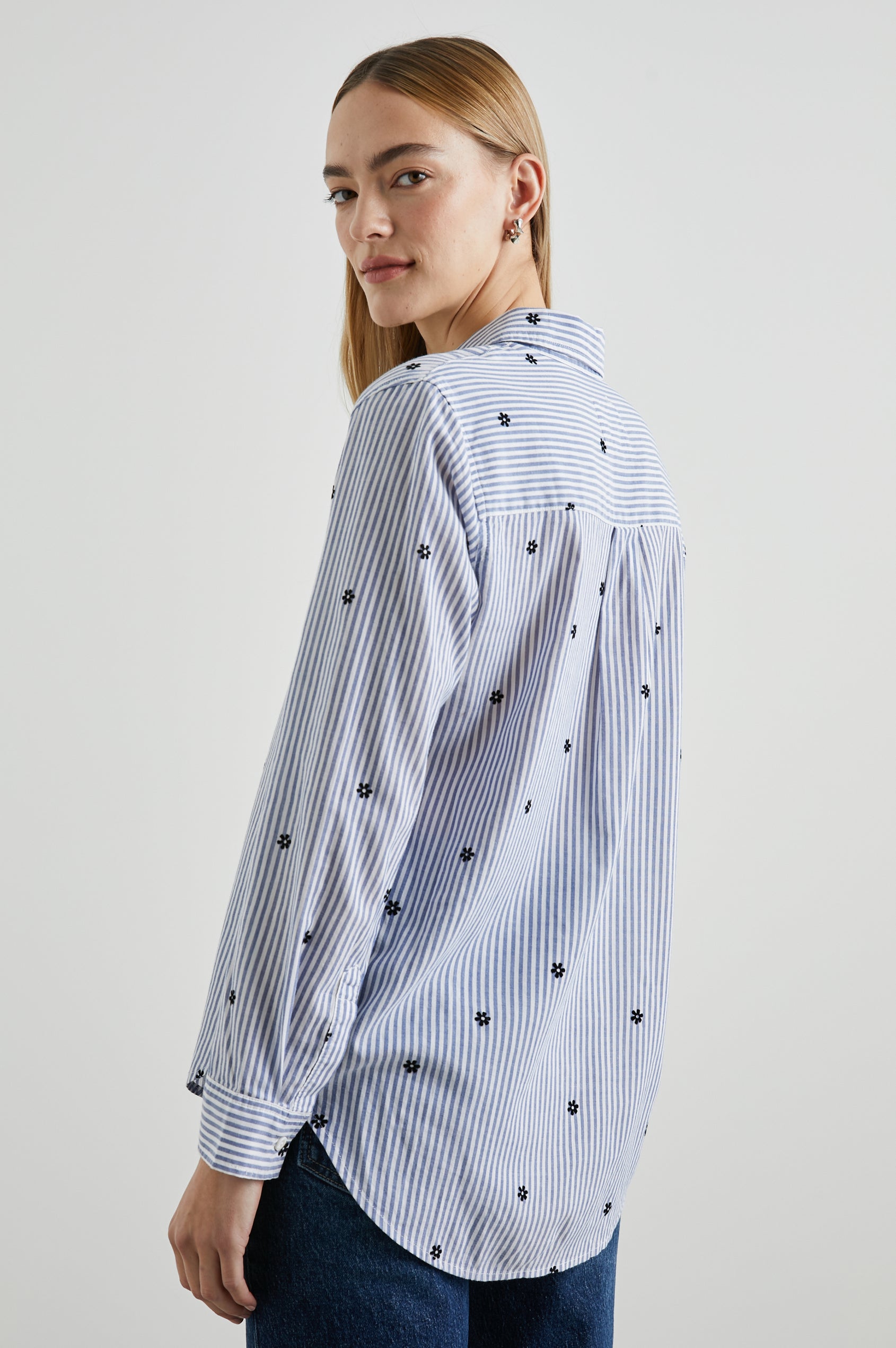 Taylor Long-Sleeve Button Up with Small Dark Navy Daisies in Flocked Daisies Colorway, with Blue and White Vertical Stripes - Back View Featured on Model
