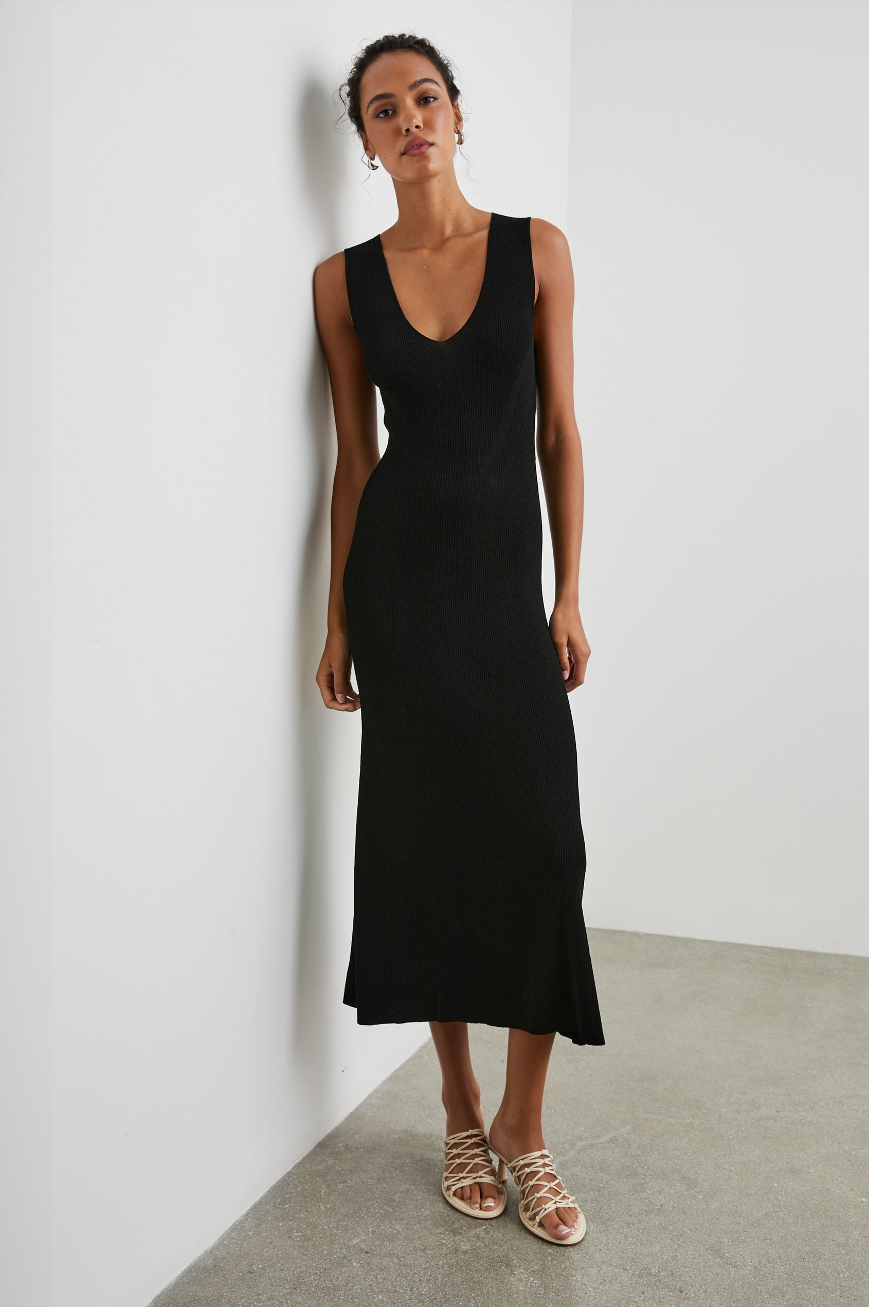 Teagan Sleeveless Ribbed Midi Dress with Wide Shoulder Straps and a Deep V Neck in Black Colorway - Front Full Body View Featured on Model 