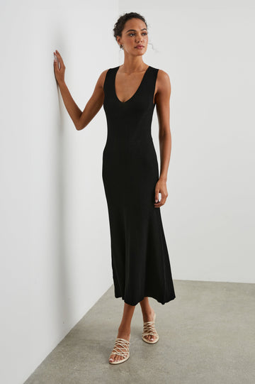 Teagan Sleeveless Ribbed Midi Dress with Wide Shoulder Straps and a Deep V Neck in Black Colorway - Front Full Body View Featured on Model 