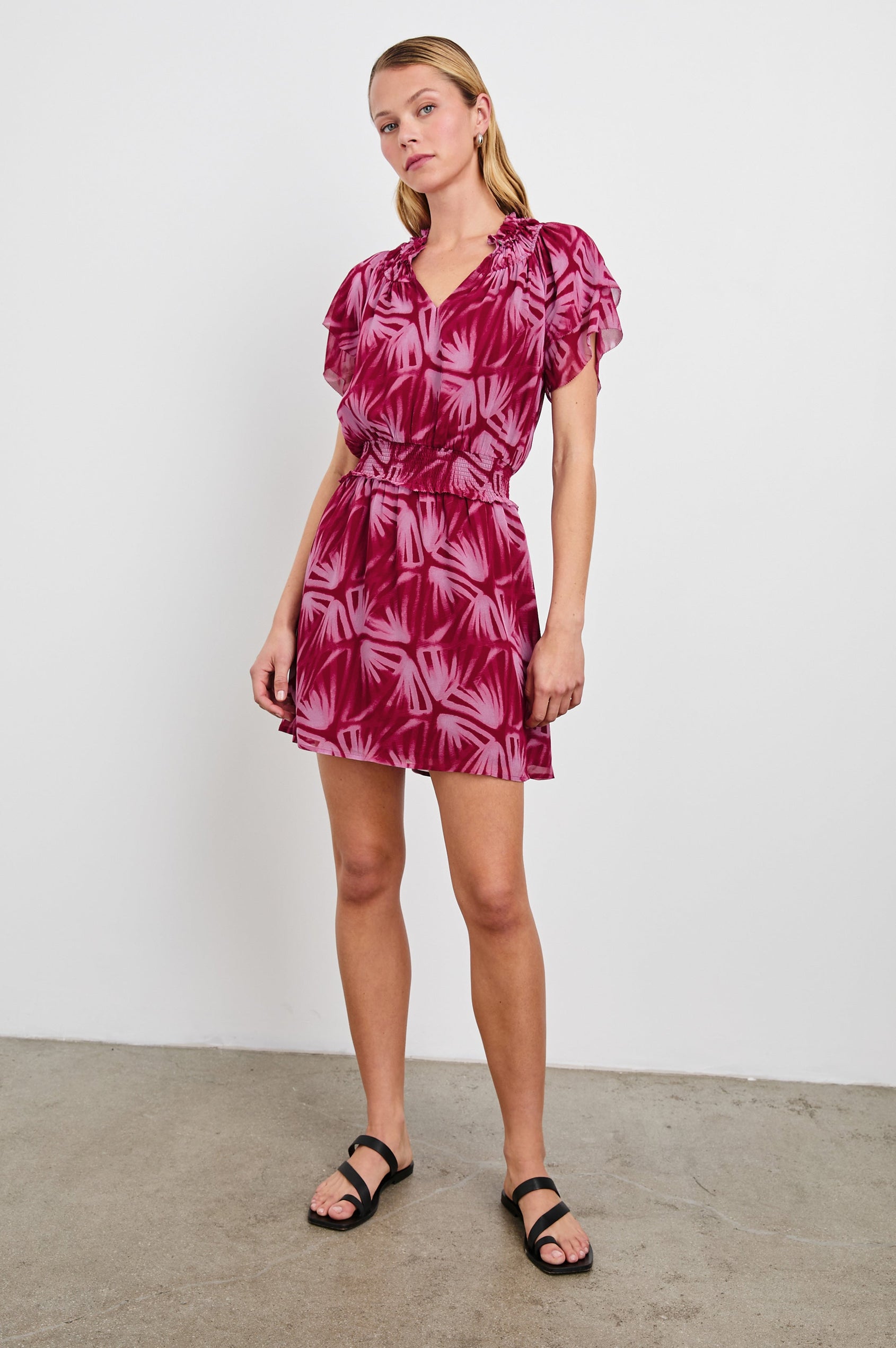 Terrin Mid-Thigh Dress with Ruffled Sleeves, a V Neck, and Shirred Collar and Waist in Bahia Colorway, a pattern in pinks - Front Full Body View Featured on model