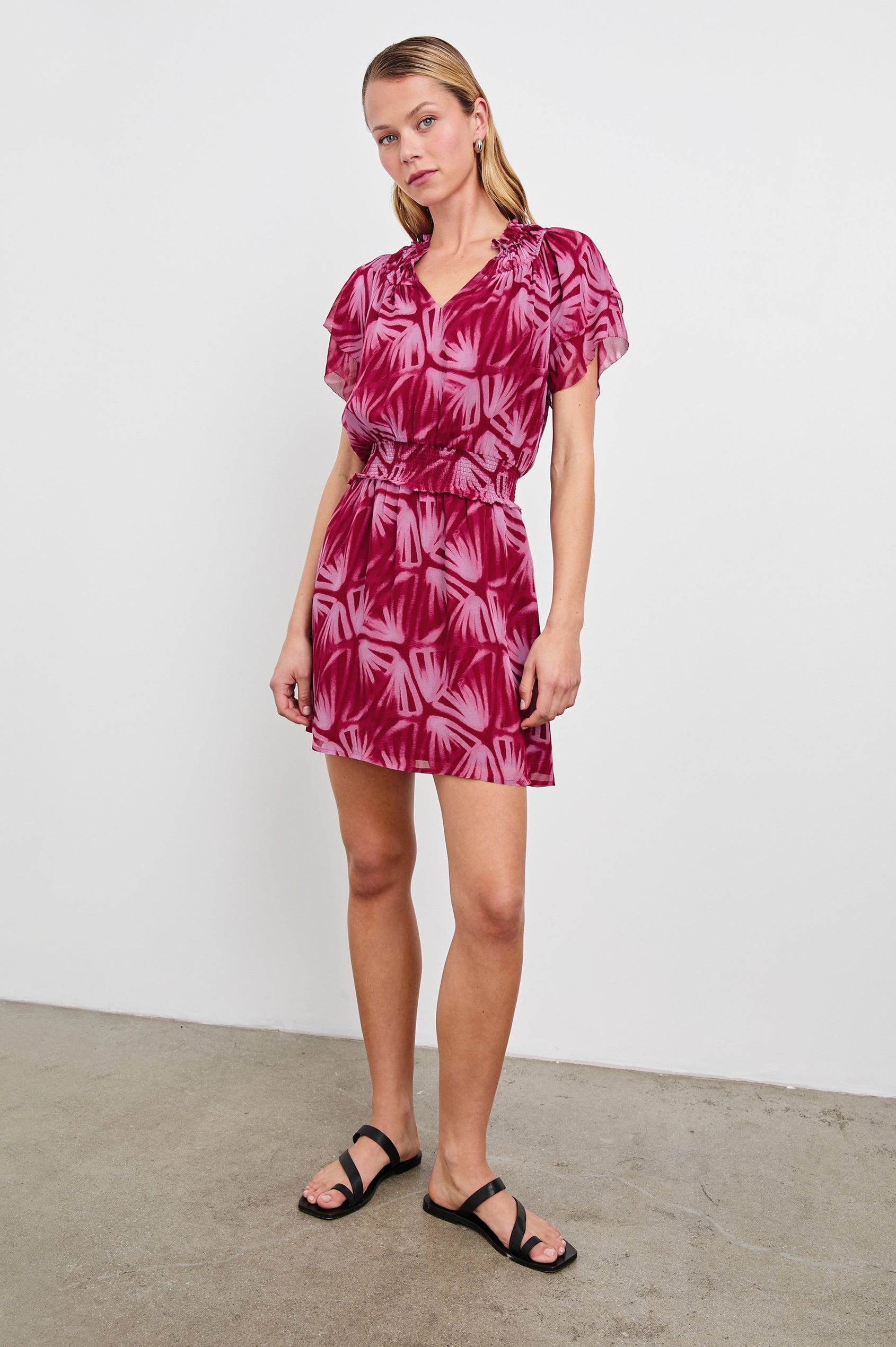 Terrin Mid-Thigh Dress with Ruffled Sleeves, a V Neck, and Shirred Collar and Waist in Bahia Colorway, a pattern in pinks - Front Full Body View Featured on model