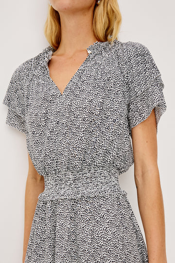 Terrin Mini Dress With Shirred Yoke, V-Neckline, Tiered Short Sleeves, Smocked Waist, and Fully Lined Skirt in Ivory Micro Spots Colorway - Upper Body Front Close Up View Featured on Model