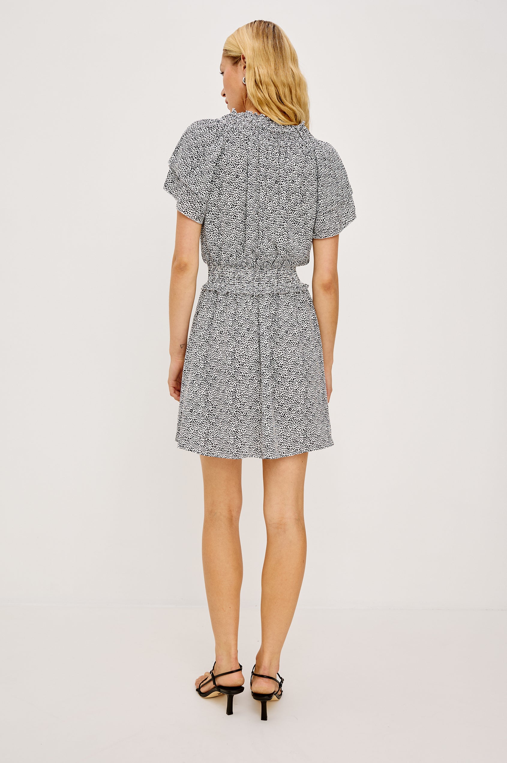 Terrin Mini Dress With Shirred Yoke, V-Neckline, Tiered Short Sleeves, Smocked Waist, and Fully Lined Skirt in Ivory Micro Spots Colorway - Full Body Back View Featured on Model