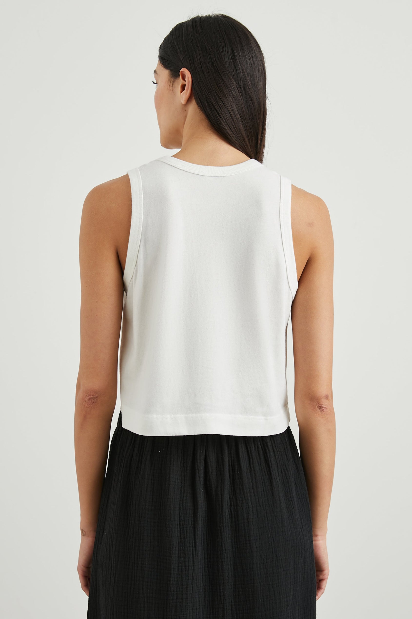 The Boxy Cropped Tank with a Crew Neck in White Colorway - Back View Featured on Model
