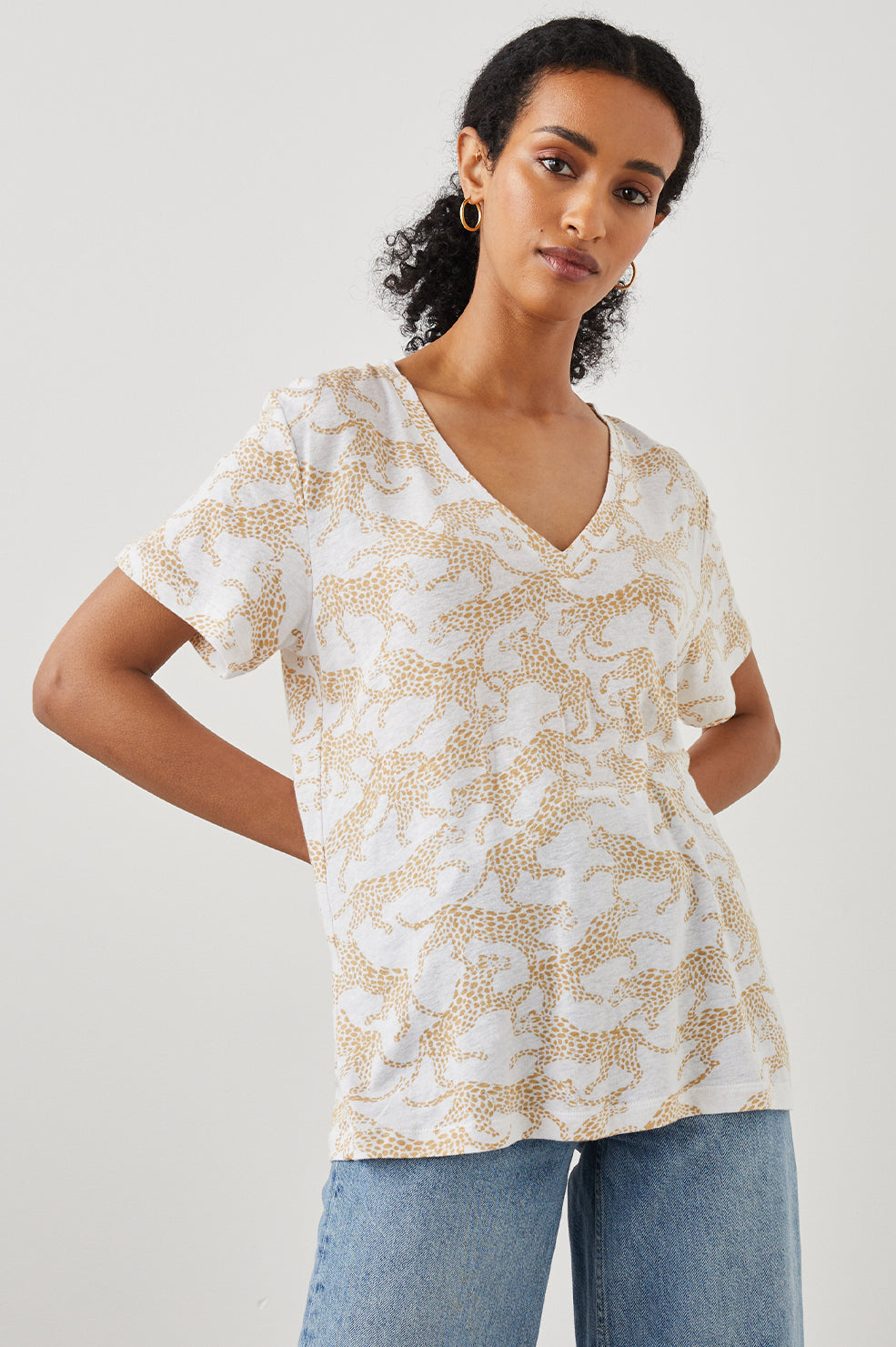 THE CARA V NECK SHIRT GOLD CHEETAH -FRONT IN MOTION