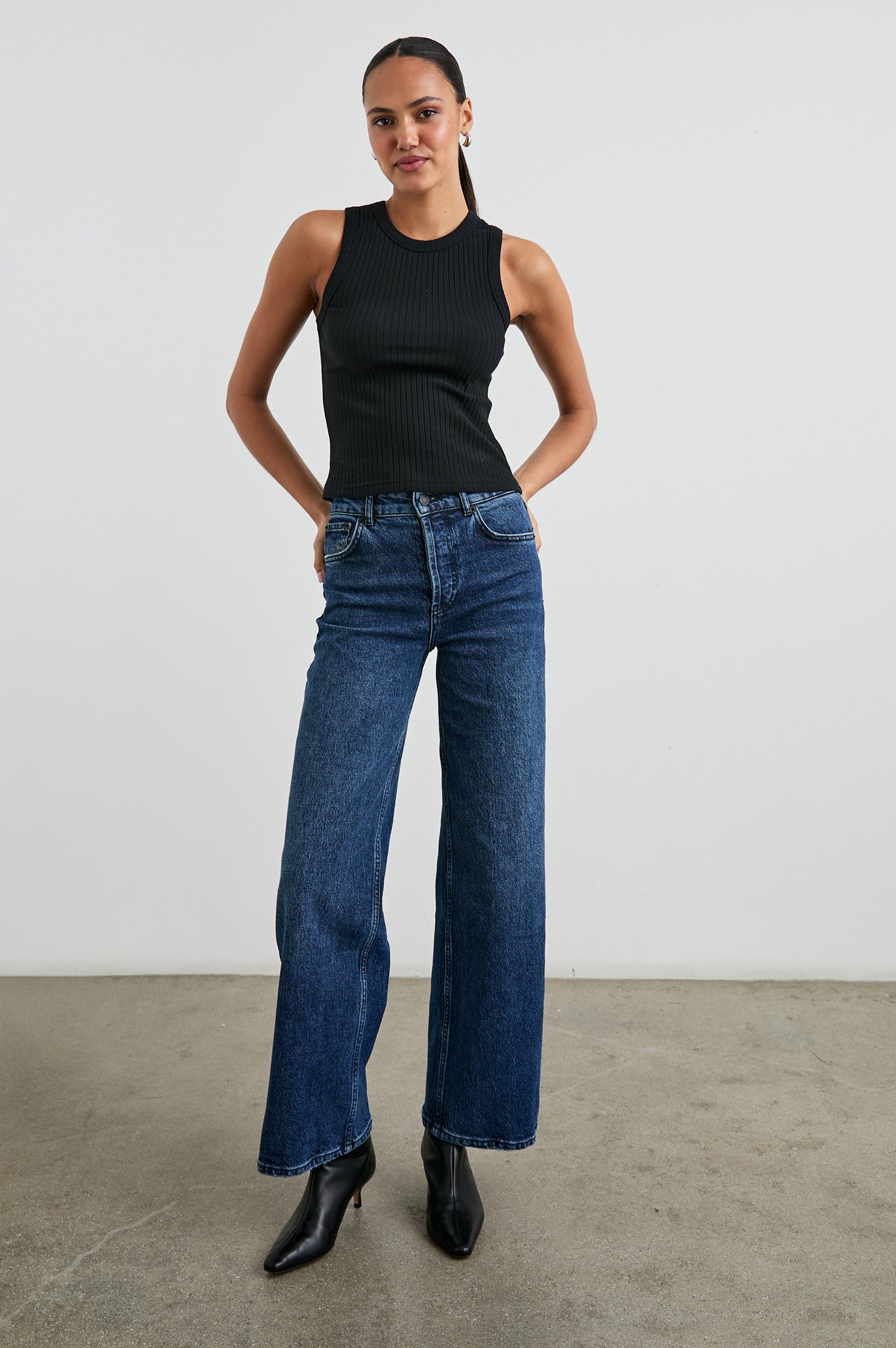 The Racer Ribbed Tank with a Crew Neckline in True Black Colorway - Front Full Body View Featured on Model