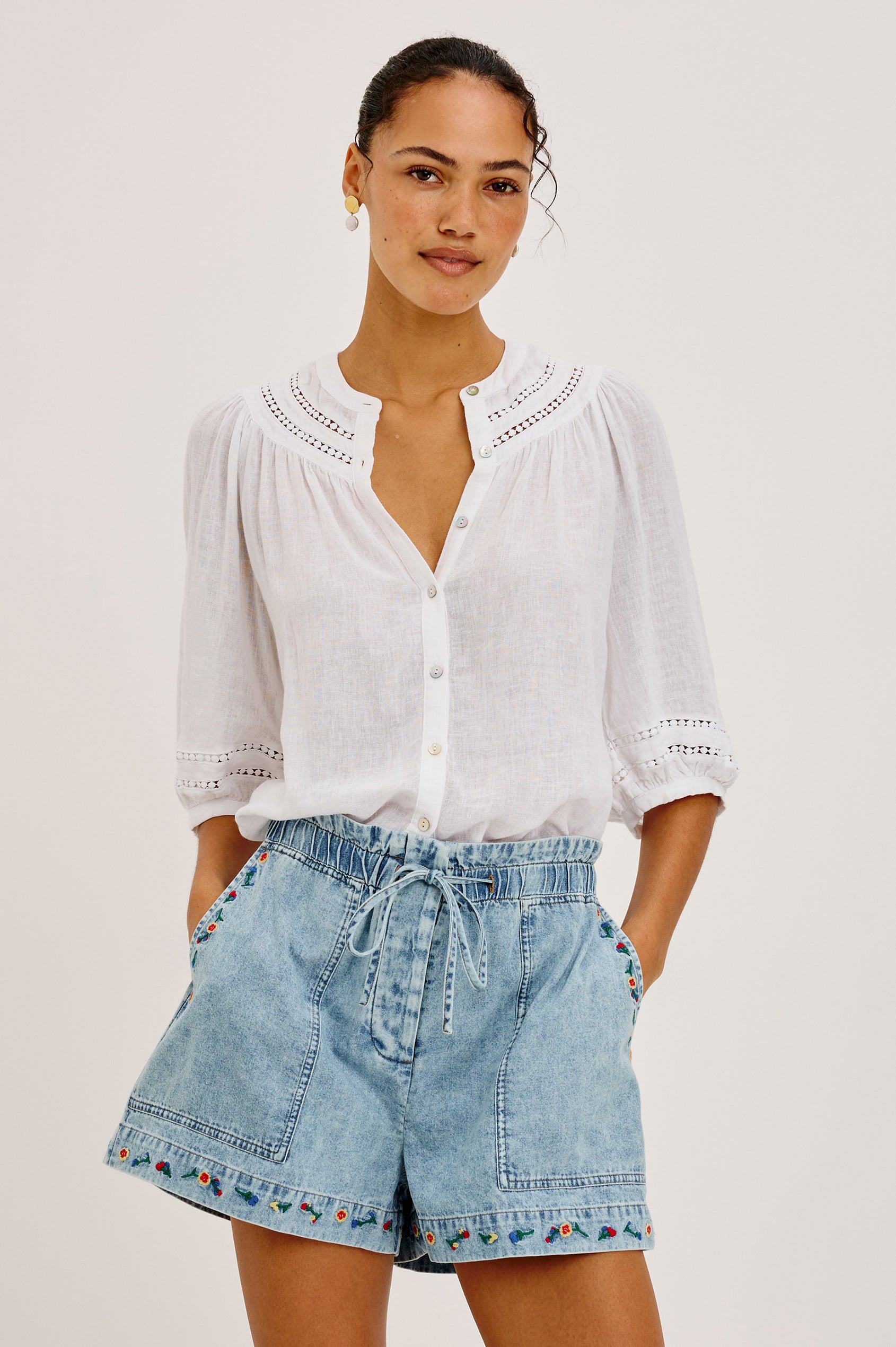 Theia Top in Luxe Linen With Crew Neckline, Front Buttons, Relaxed Fit, Embroidered Detailing, and Elbow-Length Puff Sleeves in White Colorway - Upper Body Front View Featured on Model