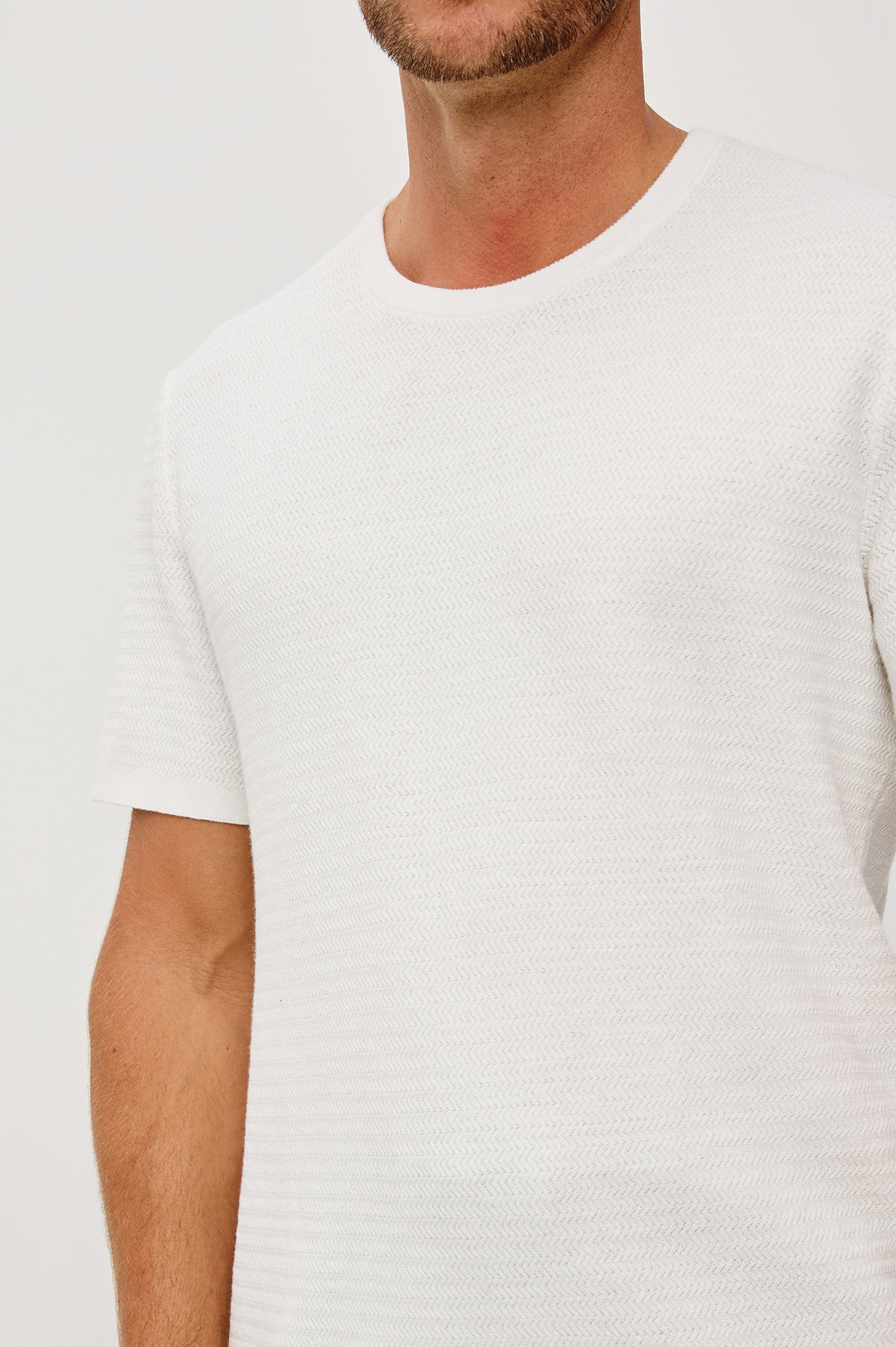 Theo T-Shirt in Ribbed Cotton-Cashmere With Crew Neckline, Short Sleeves, and Classic Fit in Porcelain Colorway - Upper Body Close Up View Featured on Model