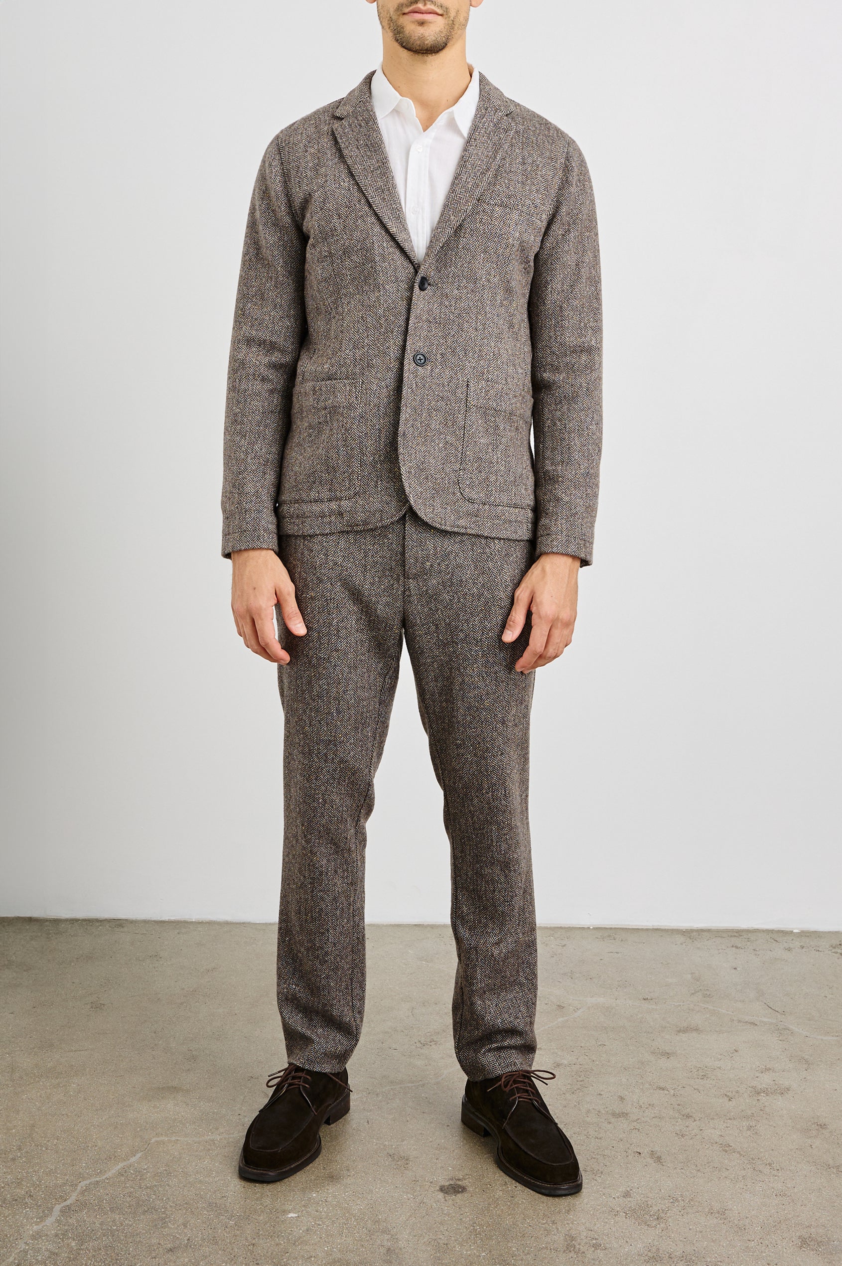 Reynard Blazer with Two Button Closure, Two Front Pockets, a Chest Welt Pocket, Herringbone Fabric in Highland Tweed Colorway, a Brown - Front Full Body View Featured on Model