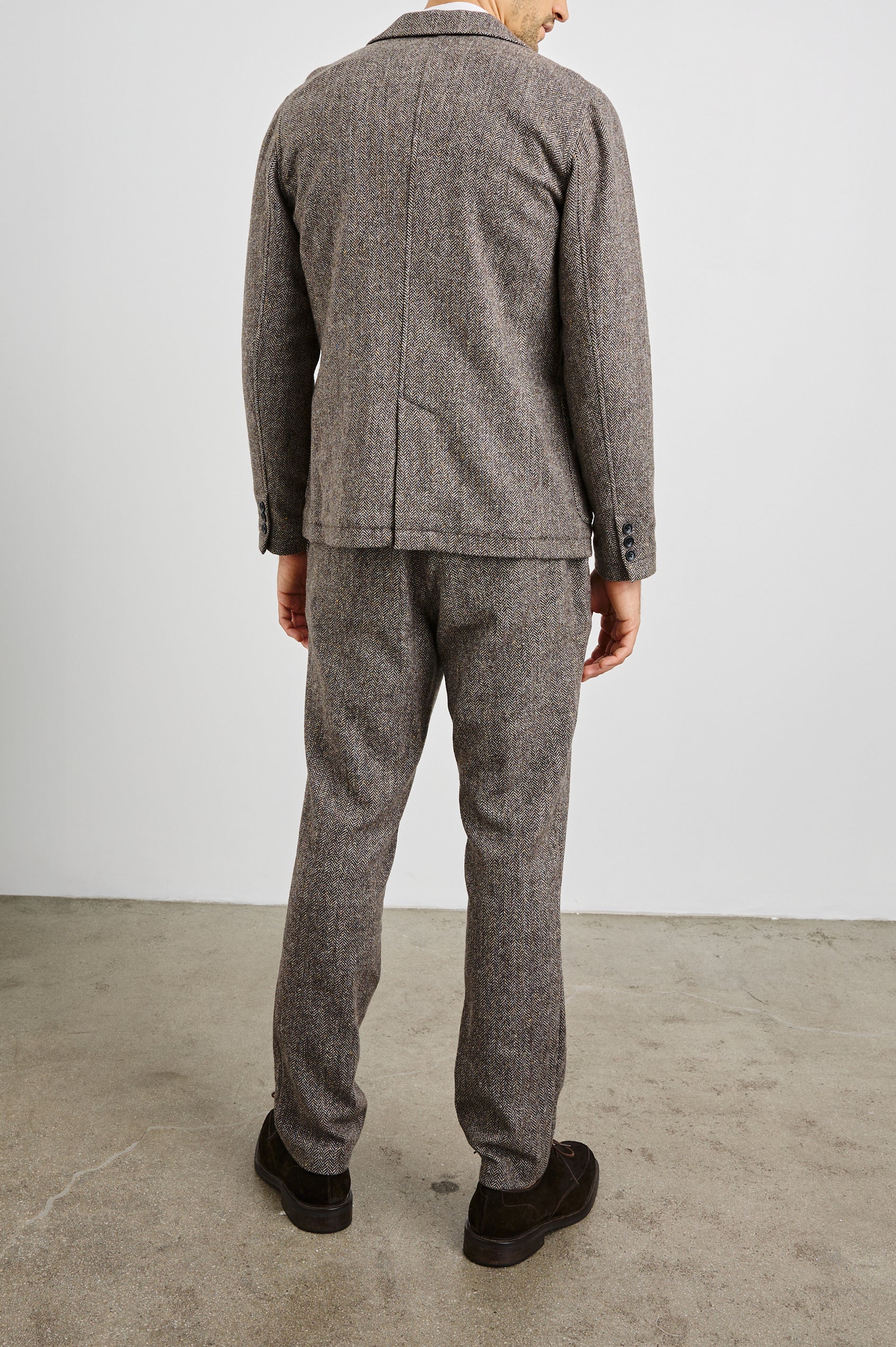 Reynard Blazer with Two Button Closure, Two Front Pockets, a Chest Welt Pocket, Herringbone Fabric in Highland Tweed Colorway, a Brown - Back Full Body View Featured on Model