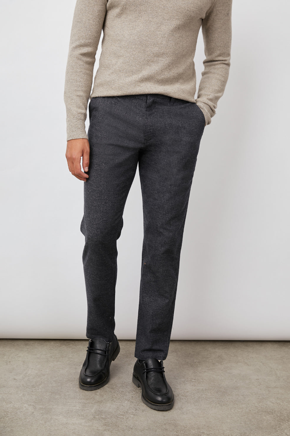 Thomas Pants with Two Front Pockets, Two Back Welt Pockets and Belt Loops in Cast Iron Colorway, a Dark Grey - Front View Featured on Model