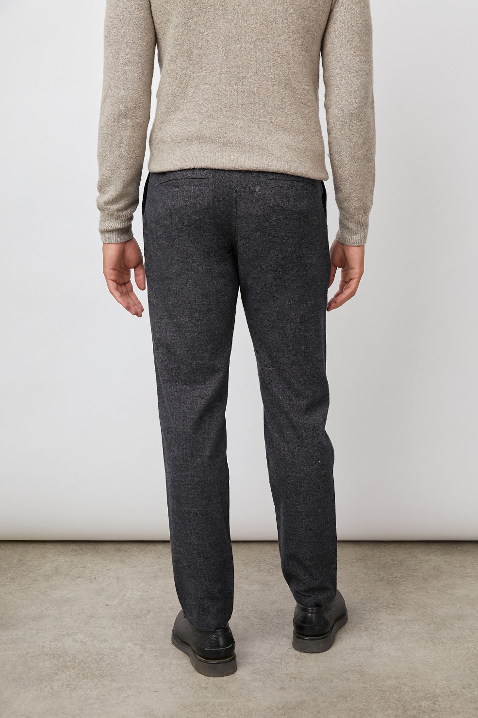 Thomas Pants with Two Front Pockets, Two Back Welt Pockets and Belt Loops in Cast Iron Colorway, a Dark Grey - Back View Featured on Model