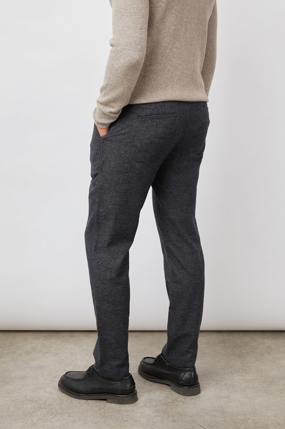 Thomas Pants with Two Front Pockets, Two Back Welt Pockets and Belt Loops in Cast Iron Colorway, a Dark Grey - Side View Featured on Model