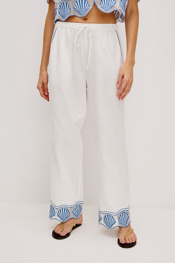 Tildi Drawstring Pant with Side Pockets, Sea Shell Embroidery and Scalloped Hem in White Colorway. Front View Shown on Model.