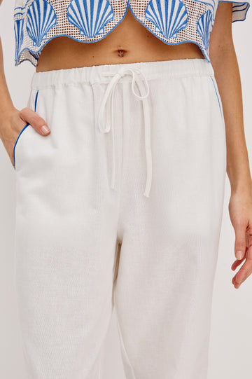 Tildi Drawstring Pant with Side Pockets, Sea Shell Embroidery and Scalloped Hem in White Colorway. Front Detail View Shown on Model.