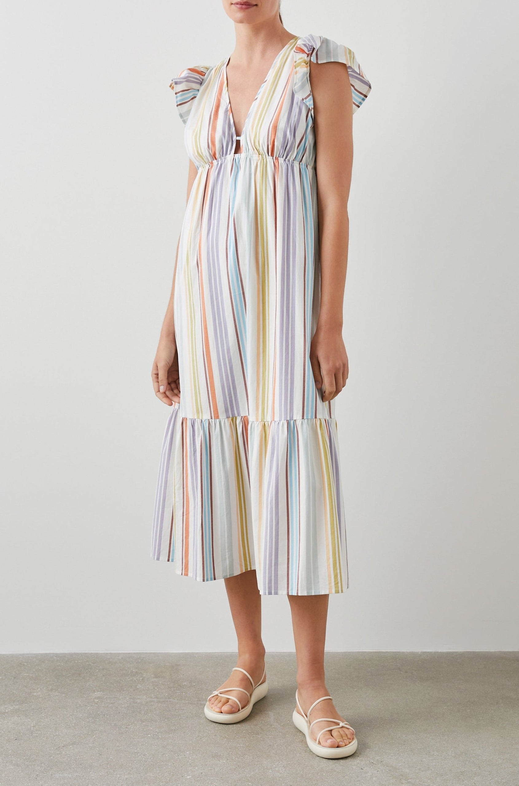 Tina Short Sleeve Midi Dress with Flutter Sleeves, a Deep V Neck with a Cutout and a Tiered Skirt in Oasis Stripe Colorway, Vertical Stripes in Green, Oranges, Purple and Blues on White - Front Full Body View Featured on Model 