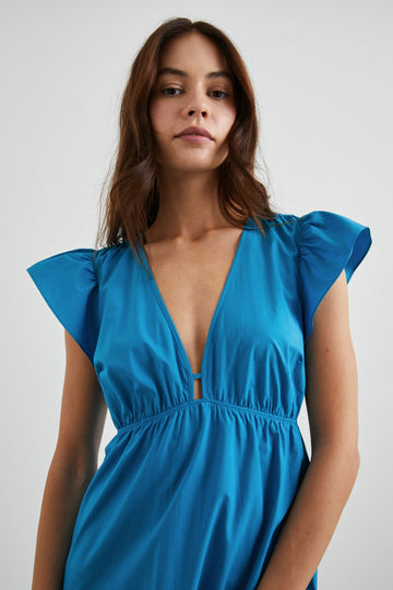 Tina Short Sleeve Midi Dress with Flutter Sleeves, a Deep V Neck with a Cutout and a Tiered Skirt in Turkish Tile Colorway, a Blue - Front View Featured on Model 