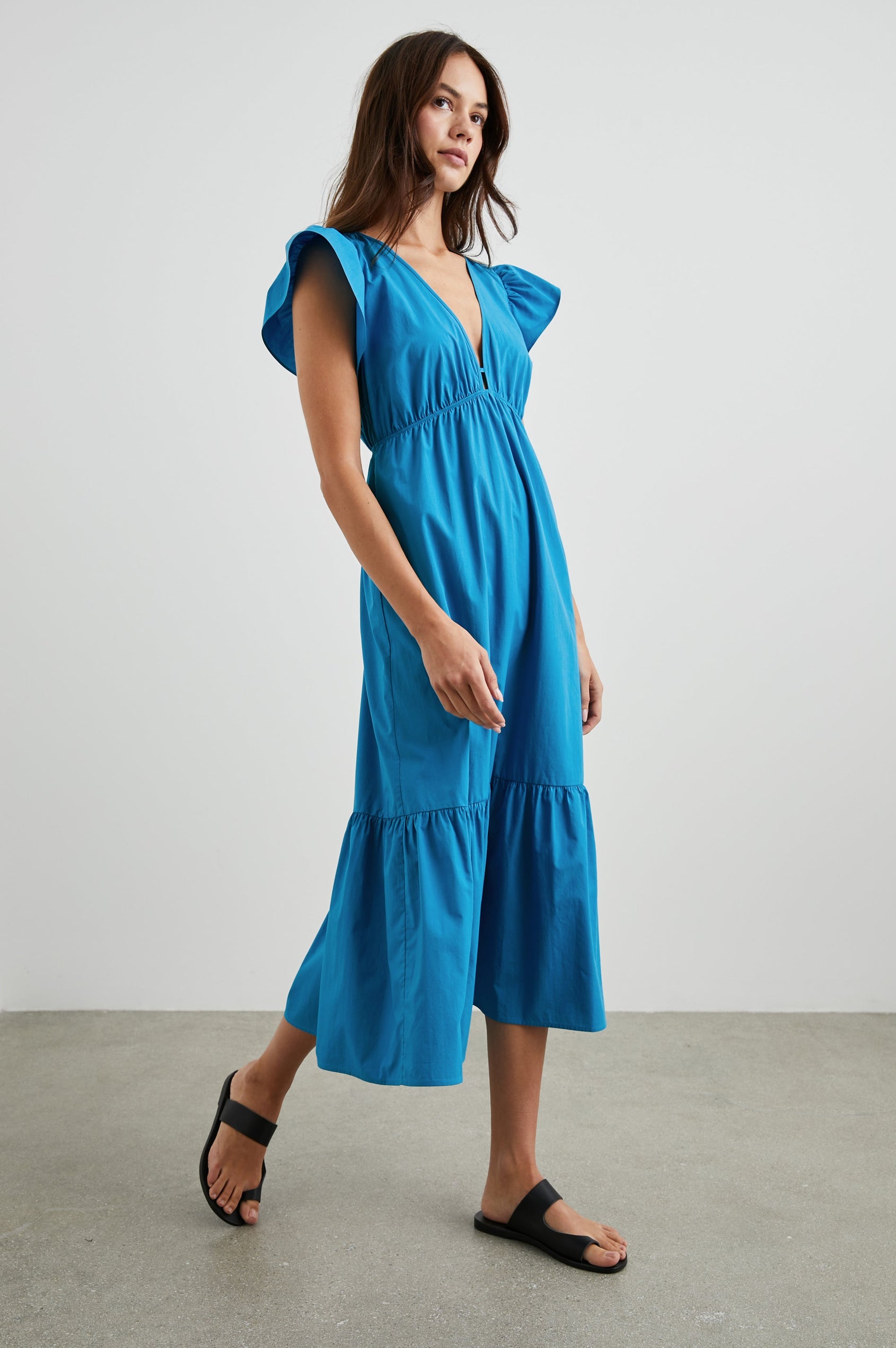 Tina Short Sleeve Midi Dress with Flutter Sleeves, a Deep V Neck with a Cutout and a Tiered Skirt in Turkish Tile Colorway, a Blue - Front Full Body View Featured on Model 