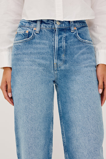 Topanga High-Rise Wide Straight Leg Jean in With 5-Pockets and a Front Zip-Fly in Baja Blue Colorway - close up View Featured on Model