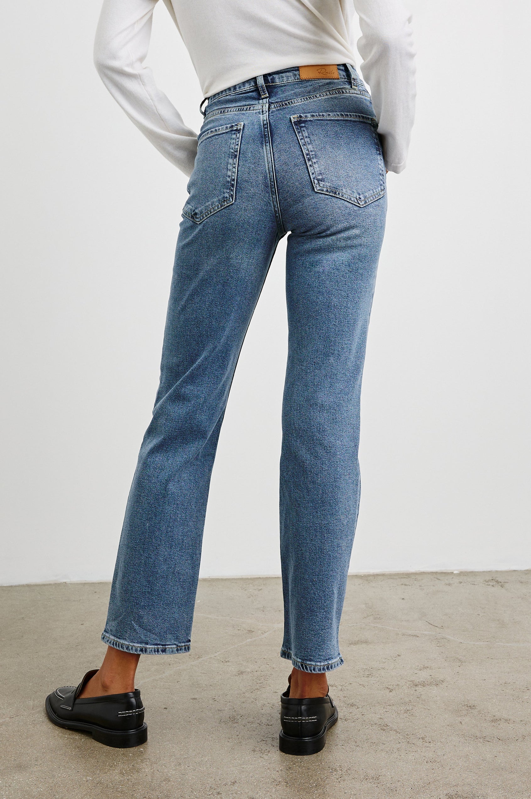 Topanga Straight Jeans with Belt Loops, Two Front Pockets plus a Coin Pocket and Two Back Patch Pockets in Blue Stone Colorway - Back View Featured on Model