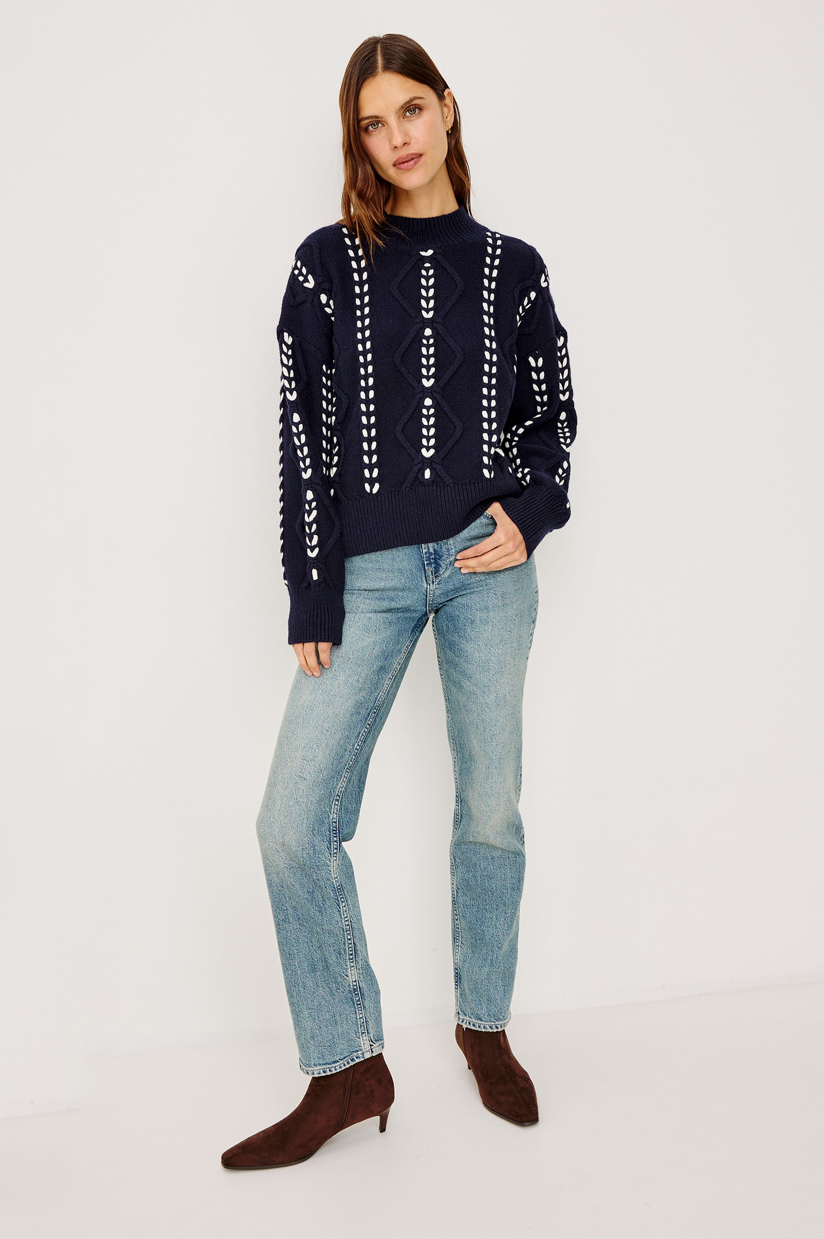 Tori Sweater in Wool Blend Cable Knit With Contrast Ribbon Stitching, a Ribbed Mock Neckline, Long Sleeves, and a Boxy Fit in Midnight Colorway - Full Body Front View Featured on Model