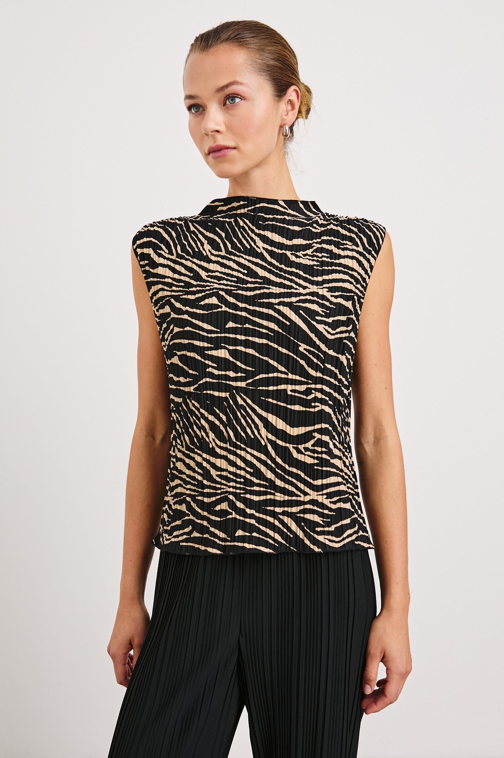 Trea Sleeveless Top with a Mock Neck and Pleated Texture in Cairo Colorway, a Black and Tan Tiger Stripe - Front View Featured on Model