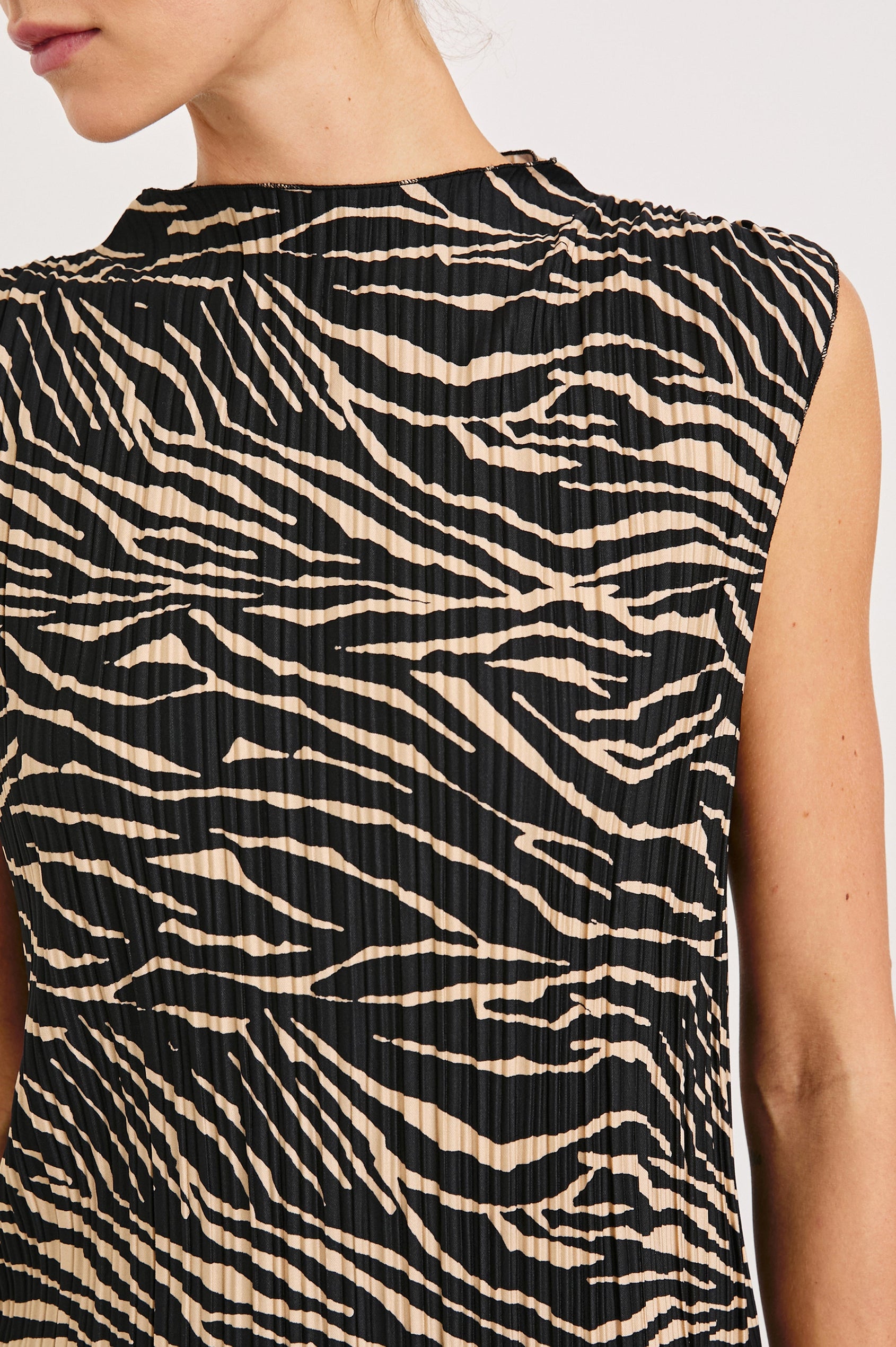 Trea Sleeveless Top with a Mock Neck and Pleated Texture in Cairo Colorway, a Black and Tan Tiger Stripe - Front View Featured on Model
